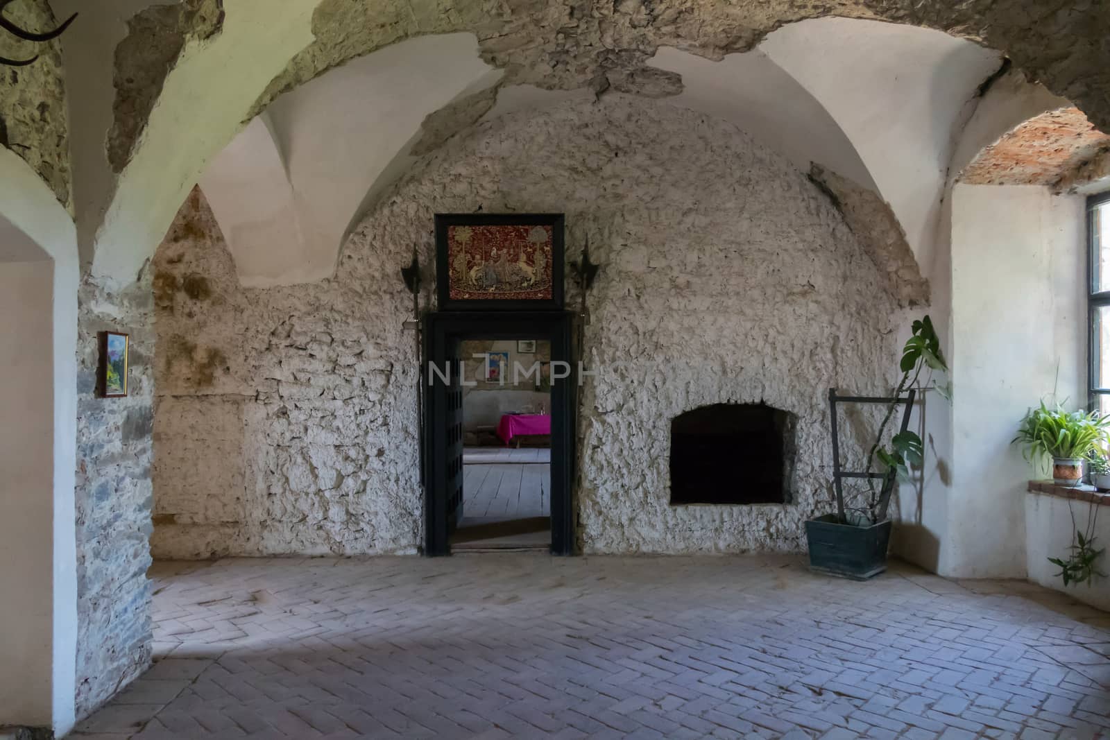 The room of the historic castle Saint Michels with a massive door and a wooden pavement on the floor. Chinadiyevo Ukraine