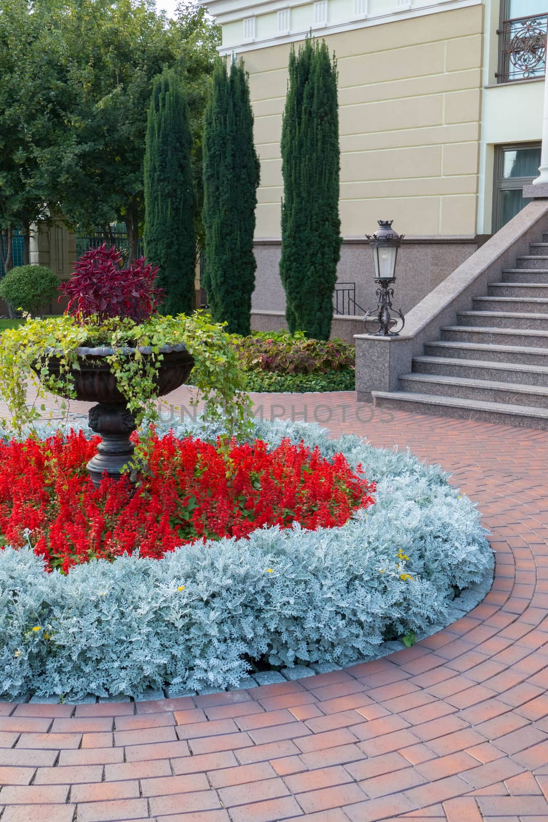 a delightful and well-kept flowerbed near the building surrounded by stones