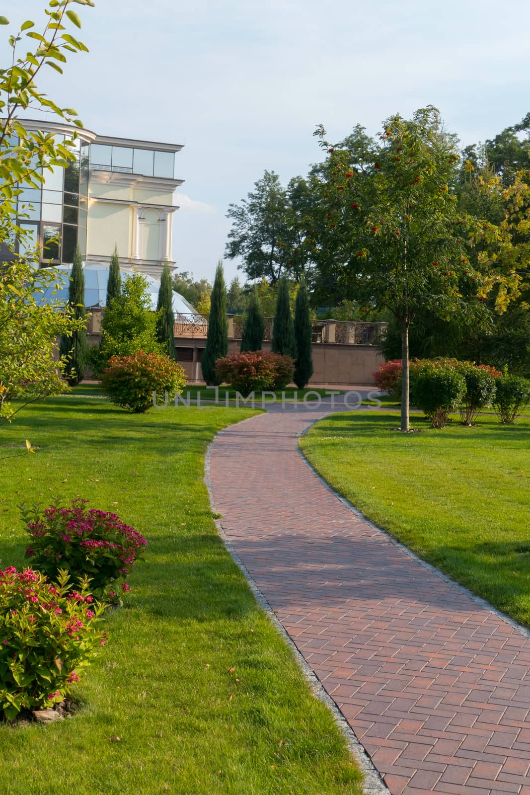 tiled track that leads to the house with a glass dome in a beautiful park