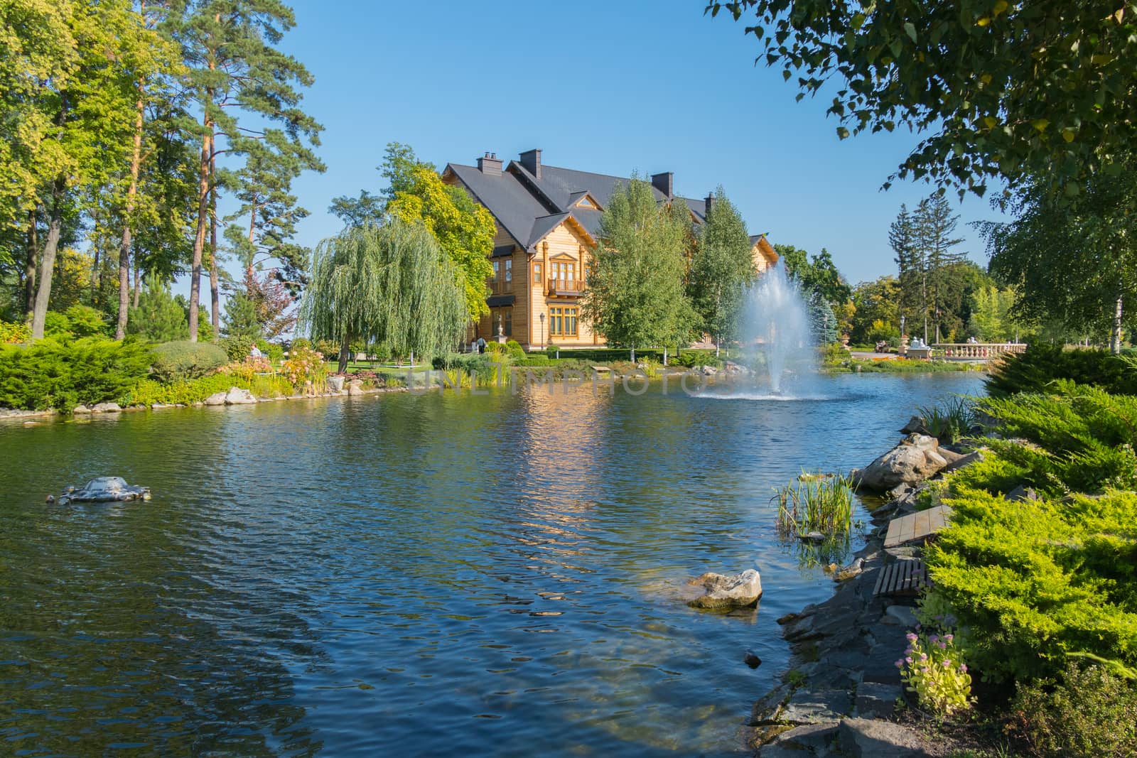 a magnificent artificial pond and a fountain hammering out of it near the country house