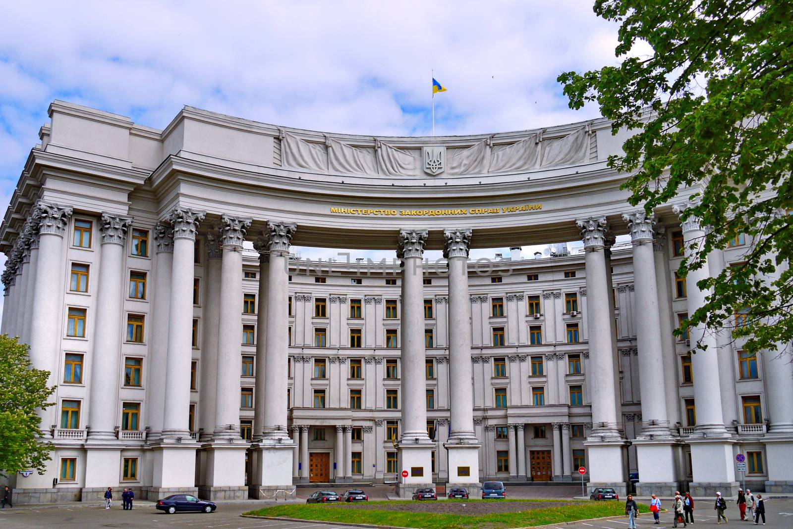Facade of the Ministry of Foreign Affairs of Ukraine against the blue sky. Patriotically, the flag flies from the wind on the roof
