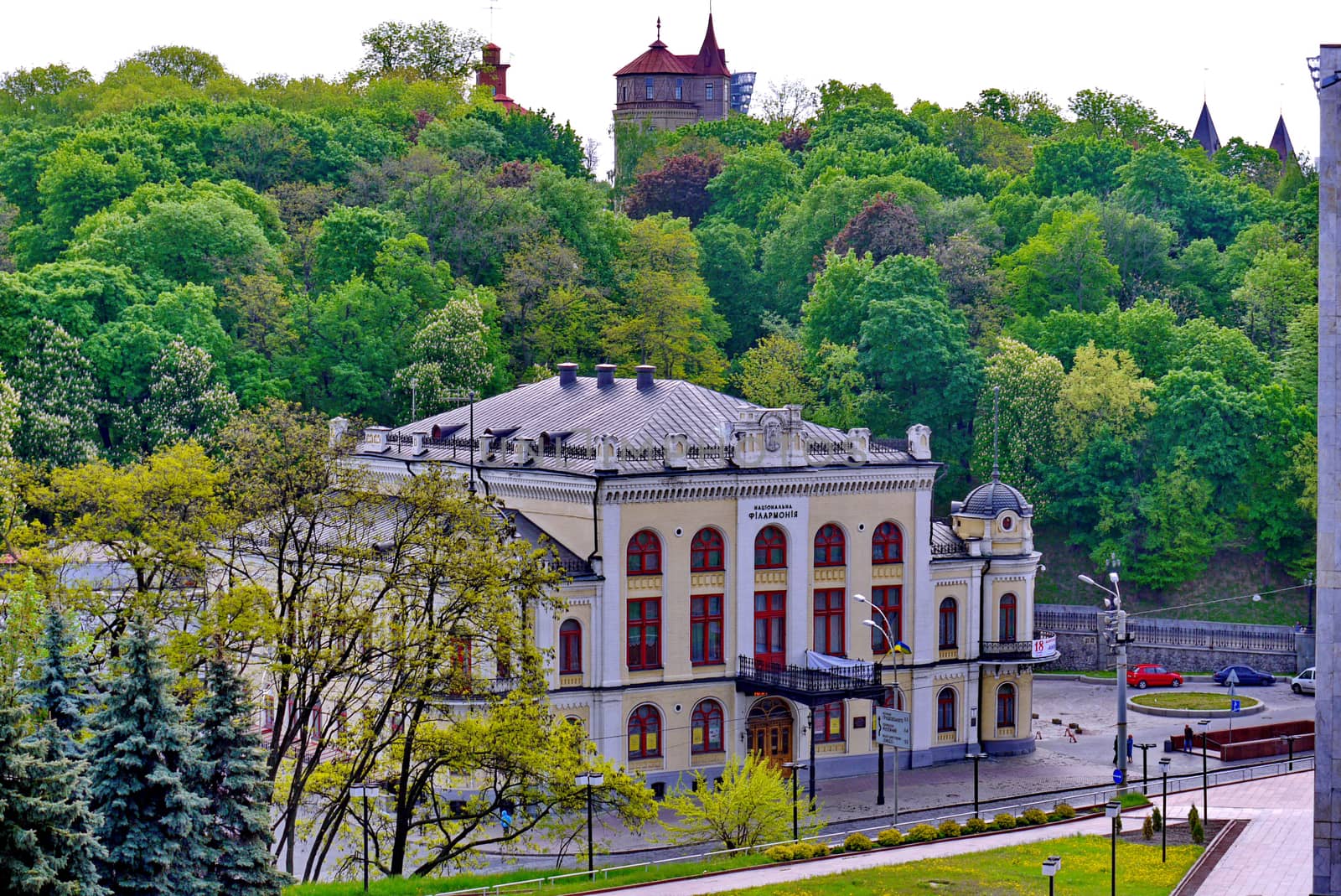White building of the philharmonic society with red window frames. There you can go to a concert and enjoy classical music