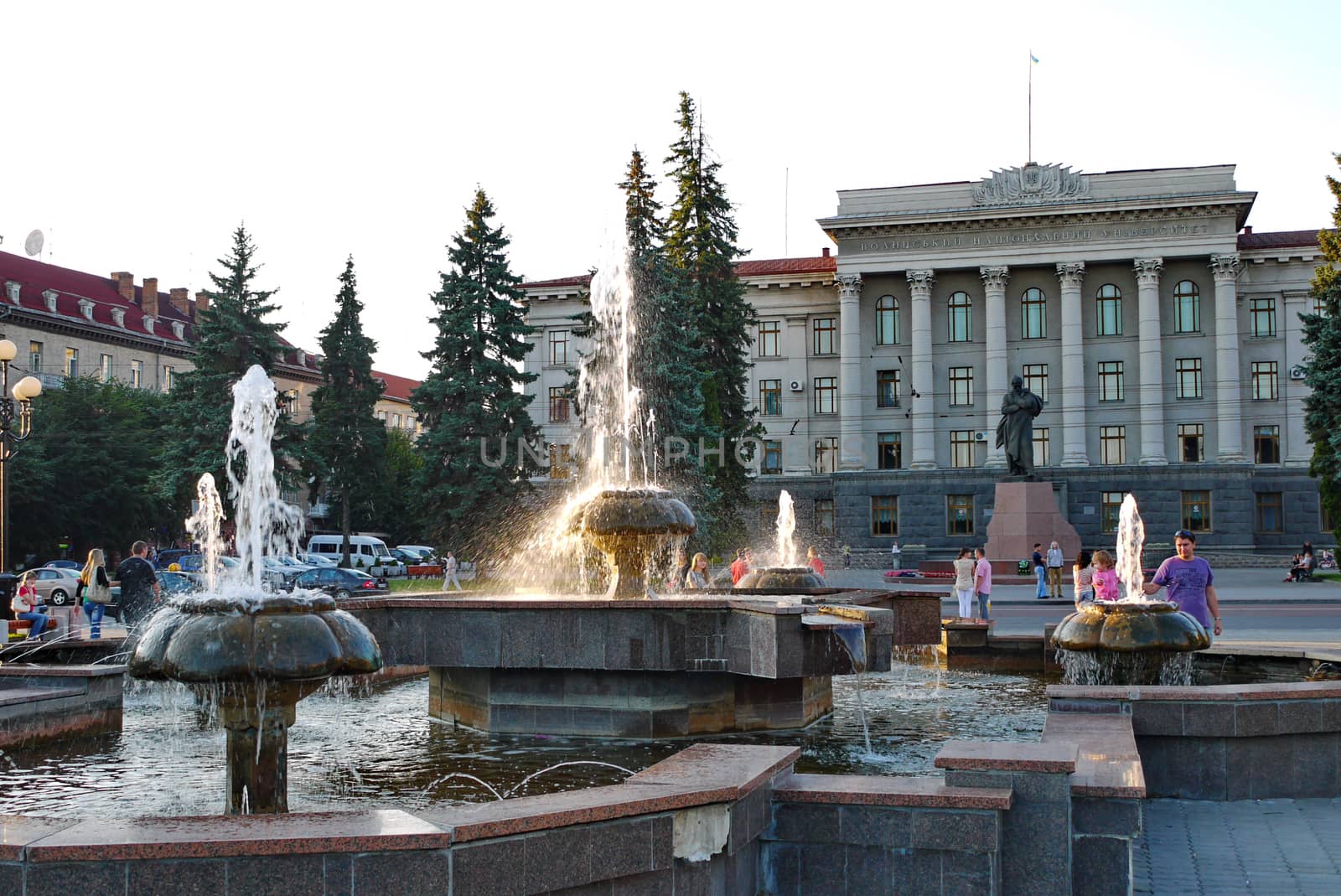 A beautiful ensemble of fountains, flower beds and statues in front of the entrance to the national university