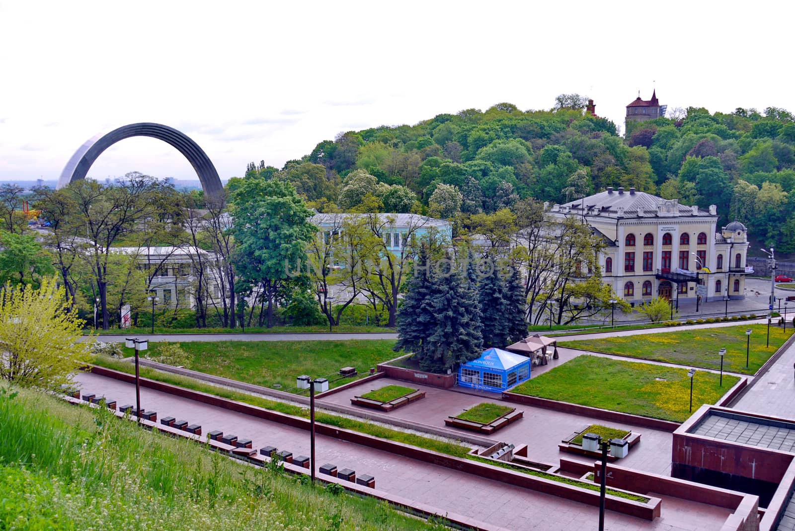A panorama of interesting architectural constructions near the park with a blue tent for rest