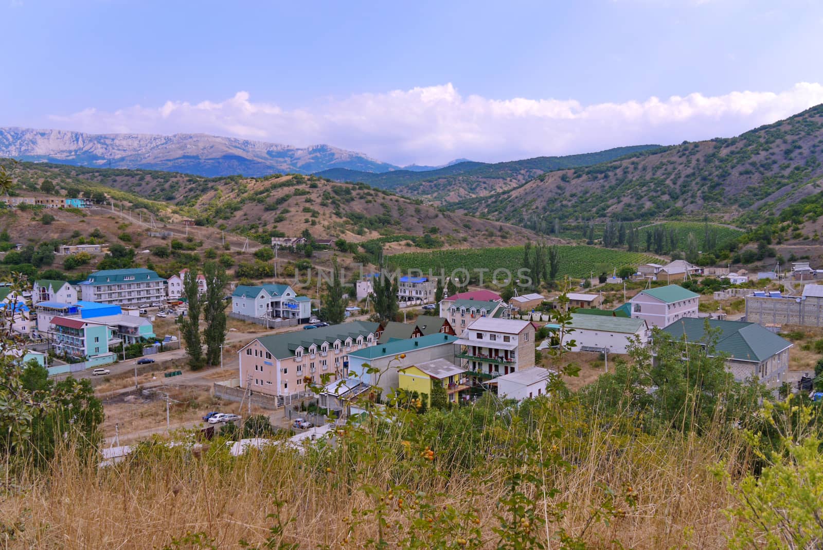 Wonderful spa houses at the foot of winding mountains against the blue sky. A place to relax with the whole family.