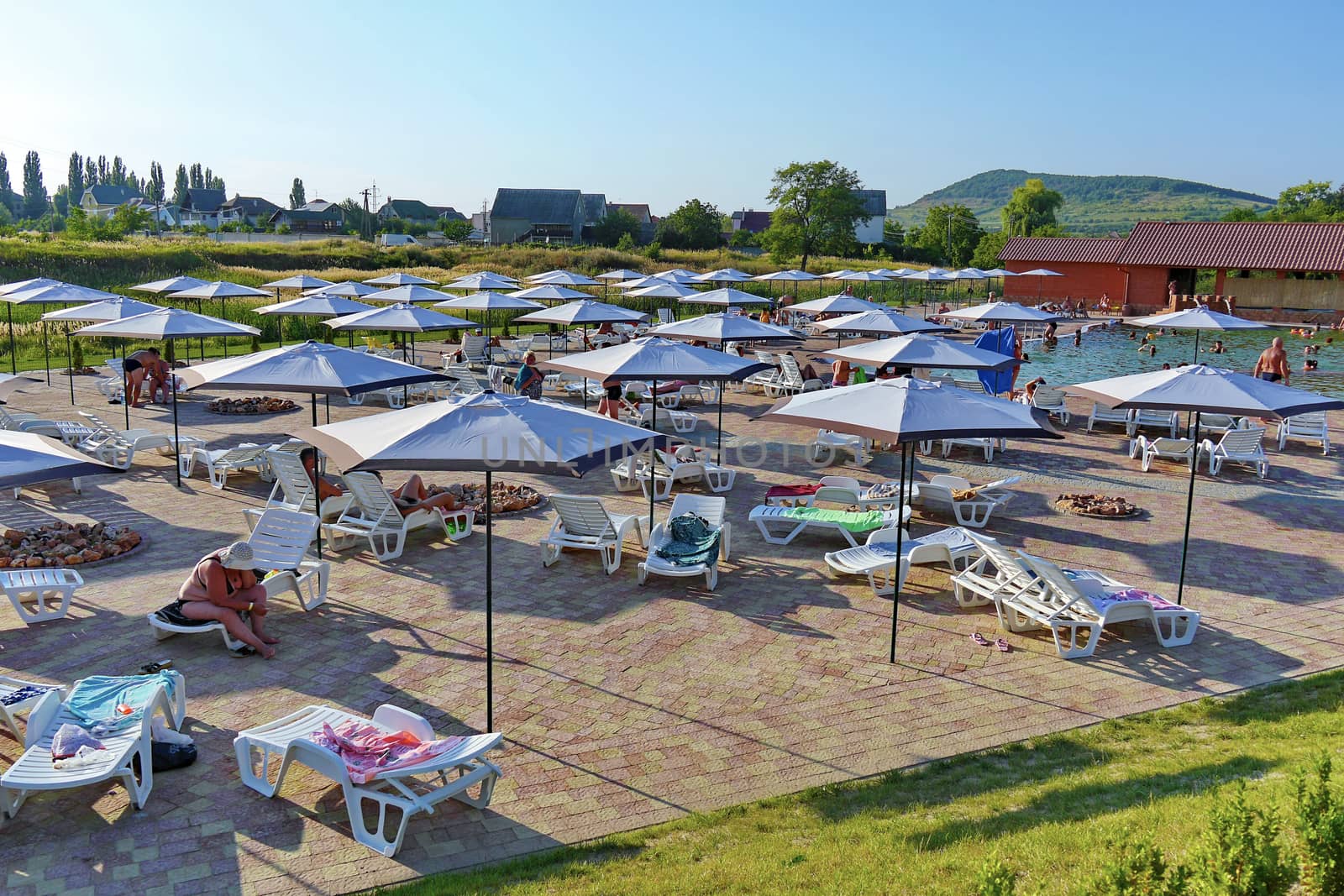 The beach is tiled with sun loungers and umbrellas. People can warm their bodies in the sun