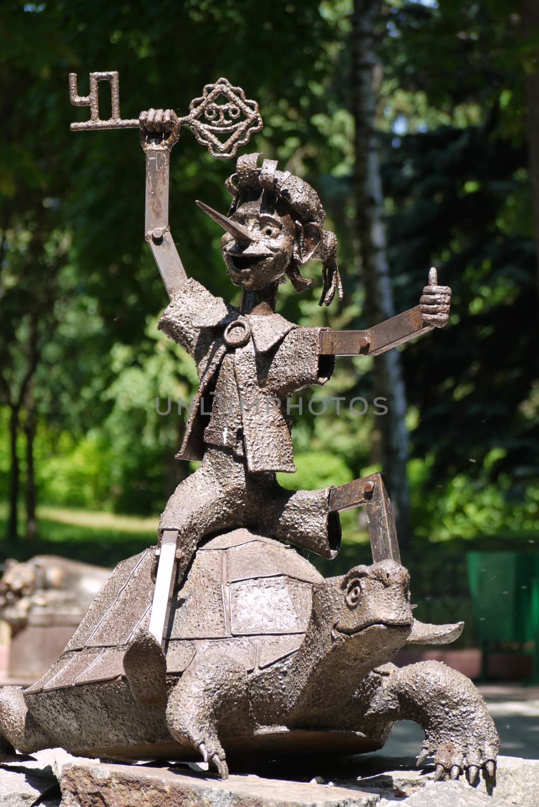 metal balloon known for the fairy tale hero Pinocchio with a golden clutch riding on a turtle