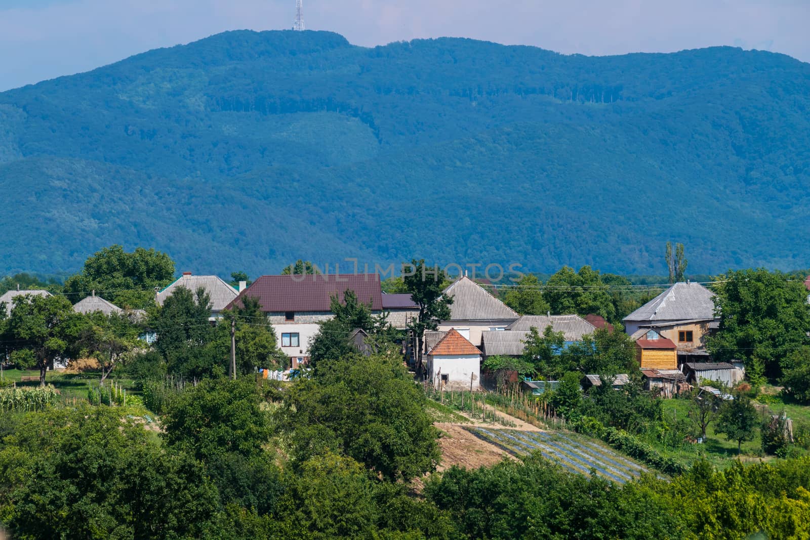 A small rural village is located in a cozy distance from the green rolling mountains