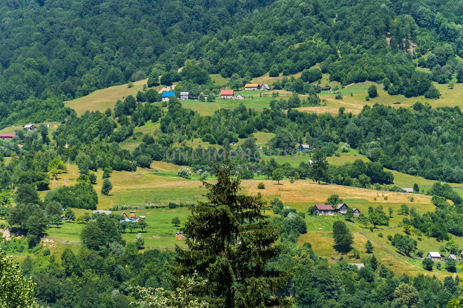 Luxurious landscape of a beautiful mountainous area with chaotic houses and picturesque nature with a glorious greenery.