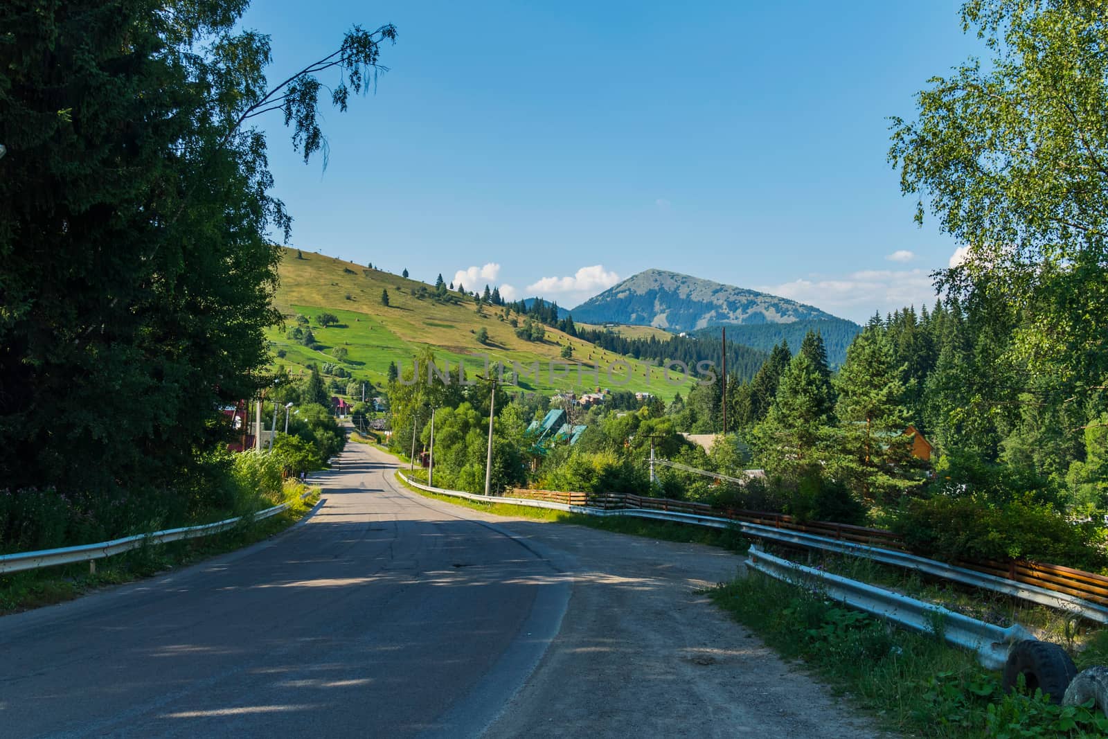 Asphalted road with a parapet through the village leading to the mountain pass