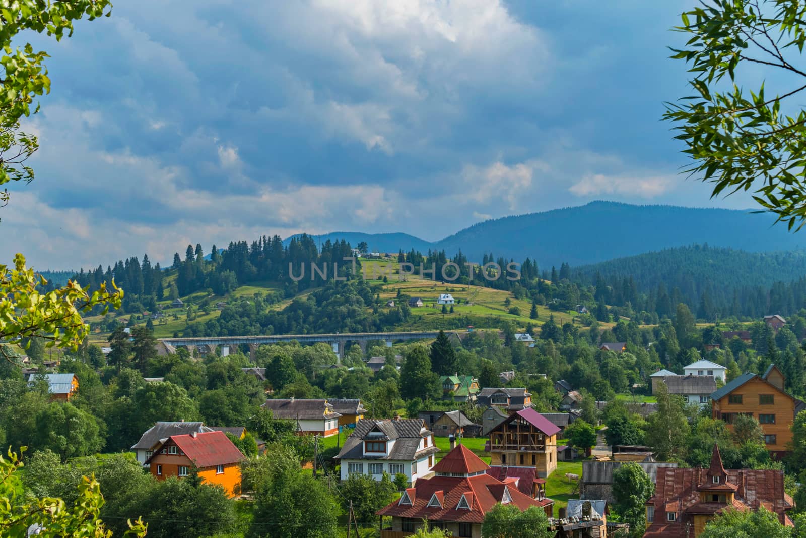 beautiful and mighty stone railroad bridge viaduct near the Carpathian town and the backdrop of the distant mountains