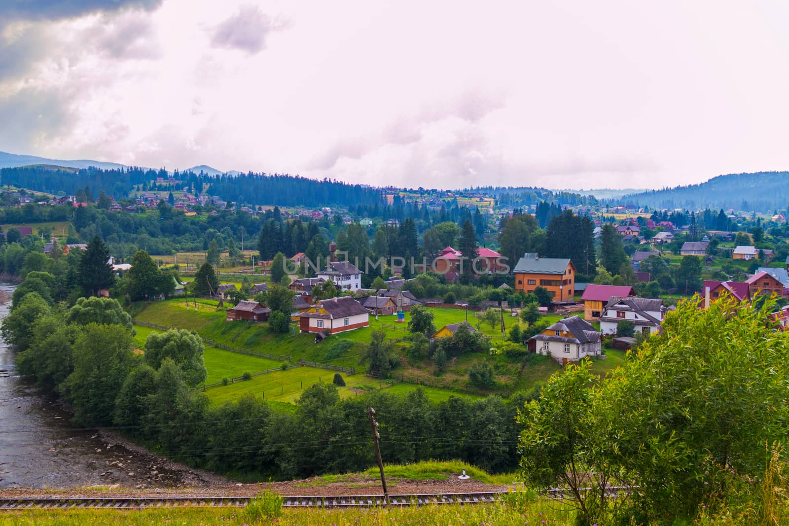 Green trees, blue mountains, a variety of roofs of houses and white clouds in the sky. What a beauty