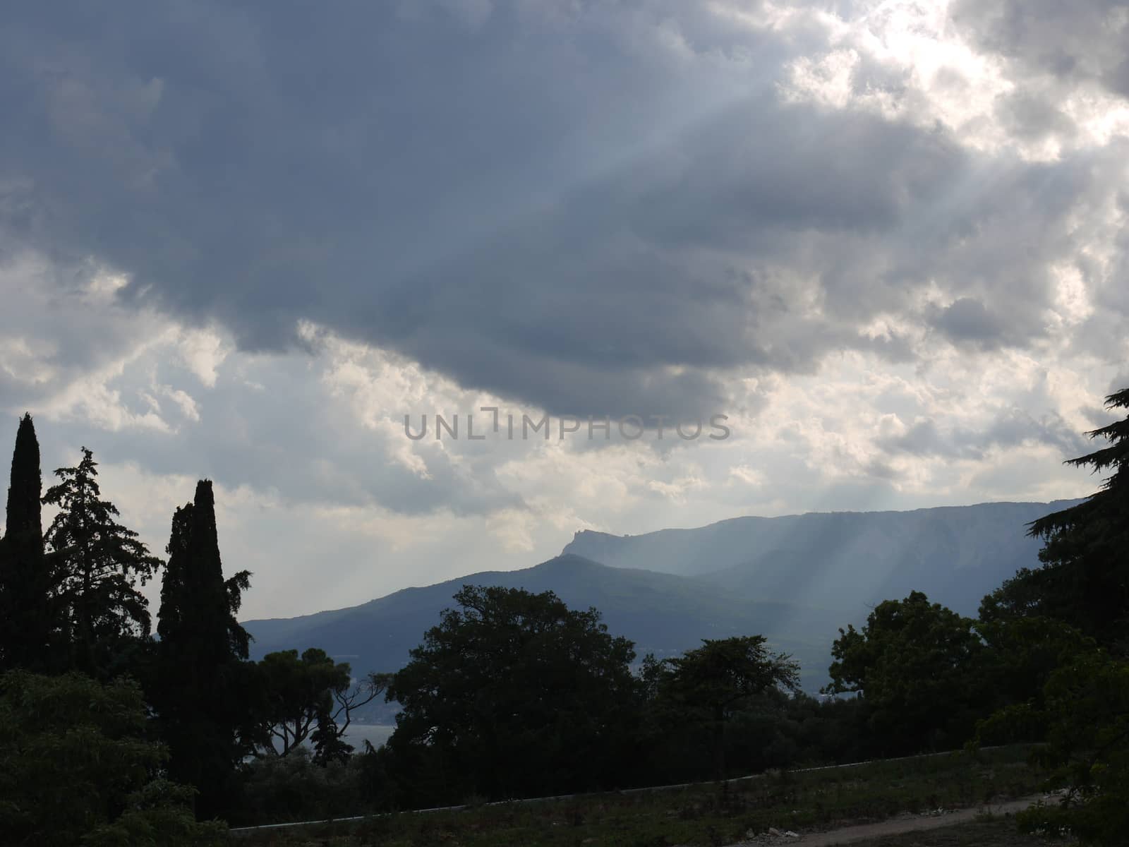 sun rays break through the blue clouds on the seafront
