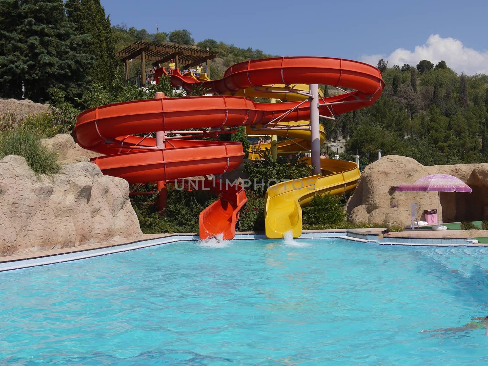 Children's slides in a park of different colors with a descent i by Adamchuk