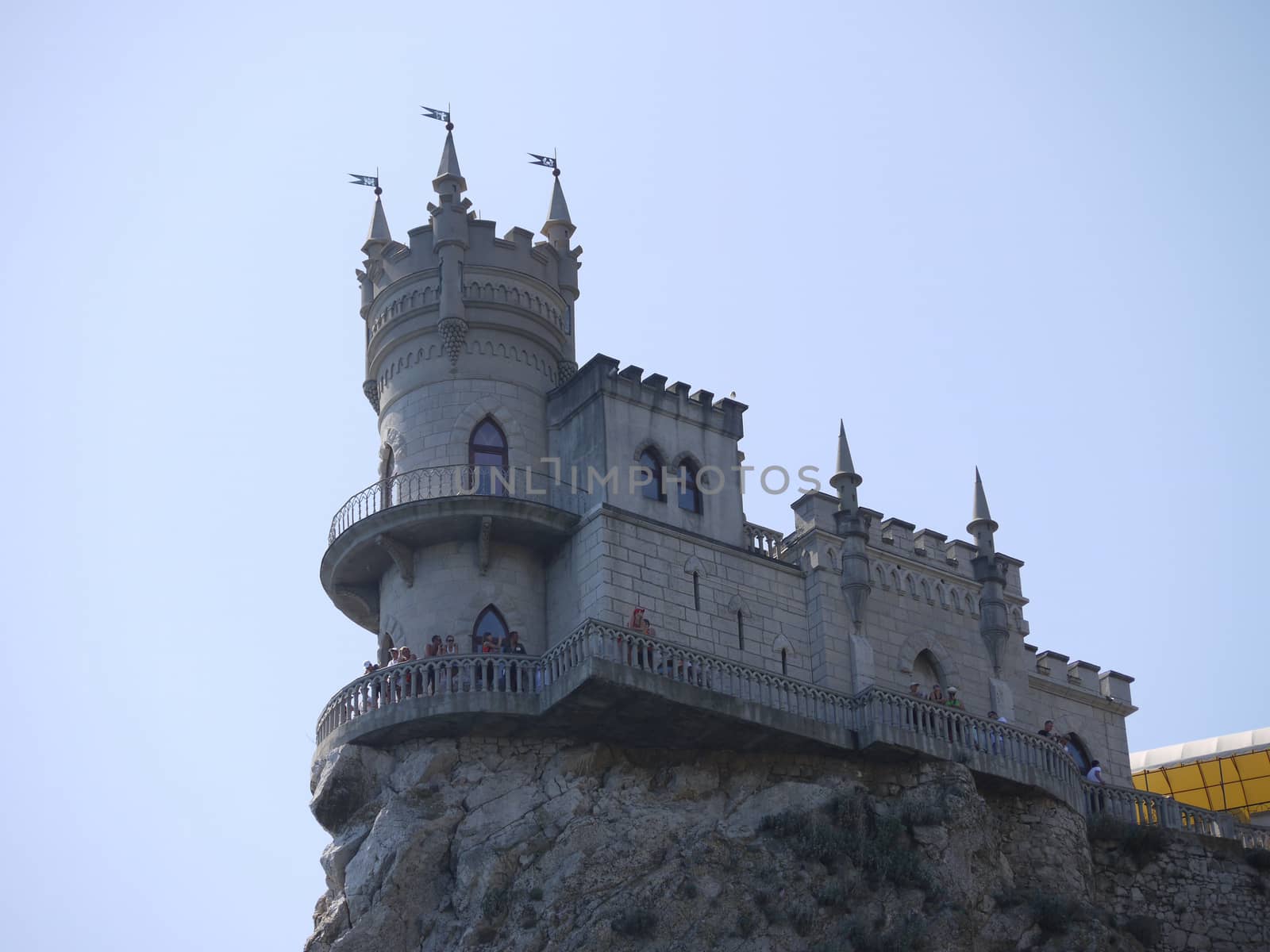 Beautiful stylized building under the antiquity, with towers and flags on the rock. The perfect place for a photo to remember