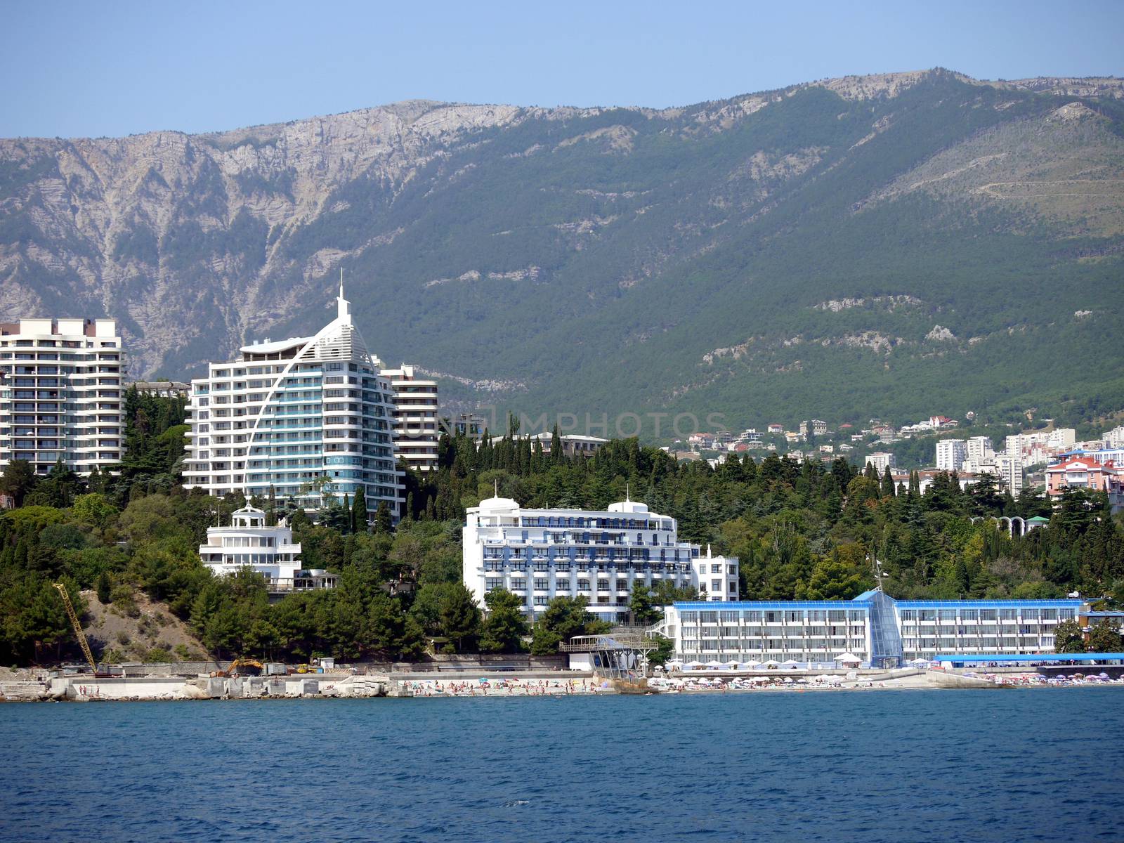 Luxury hotels with their own beaches near the sea on the background of high green mountains