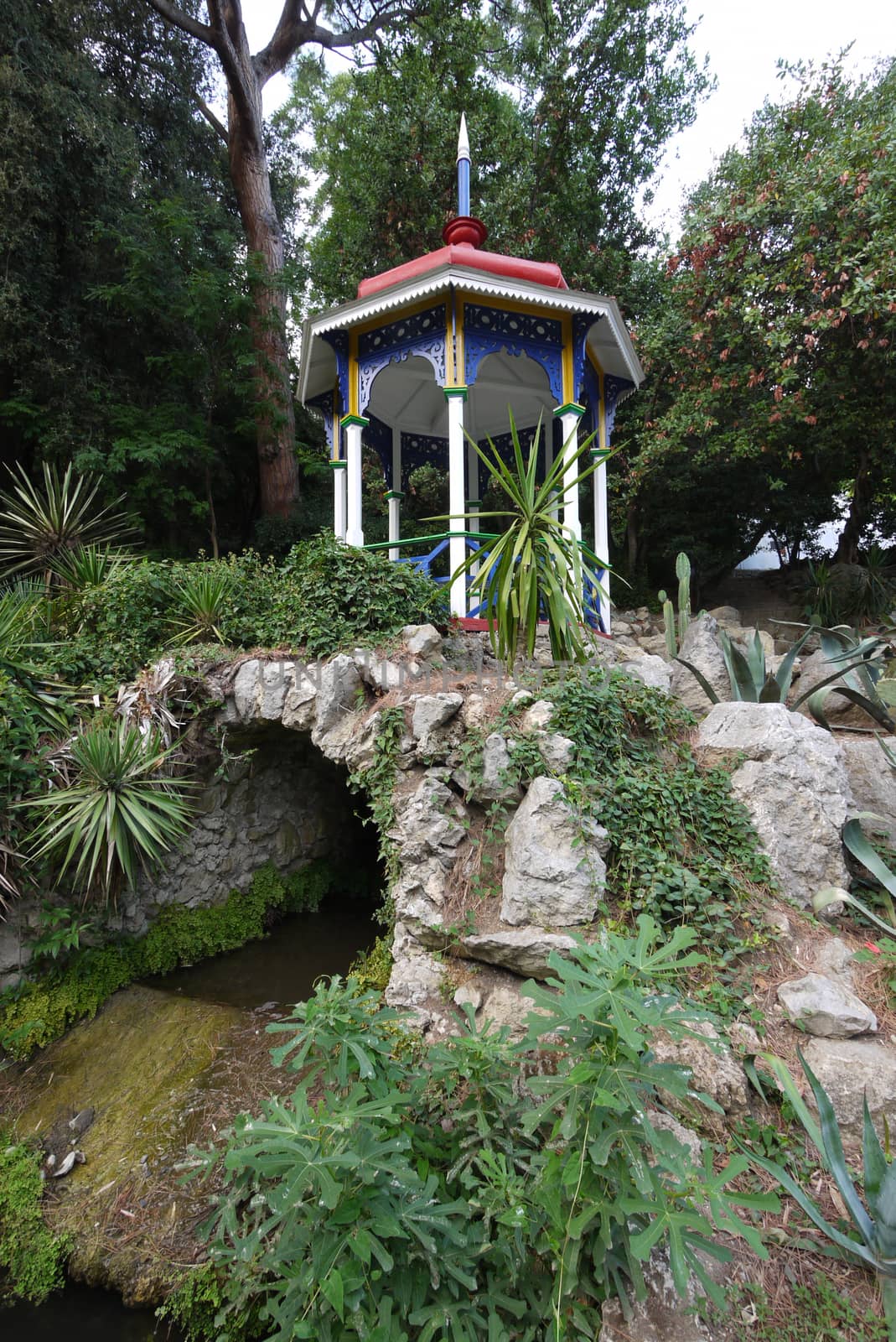 Decorative foliage with colored ornamental details on a stone arch
