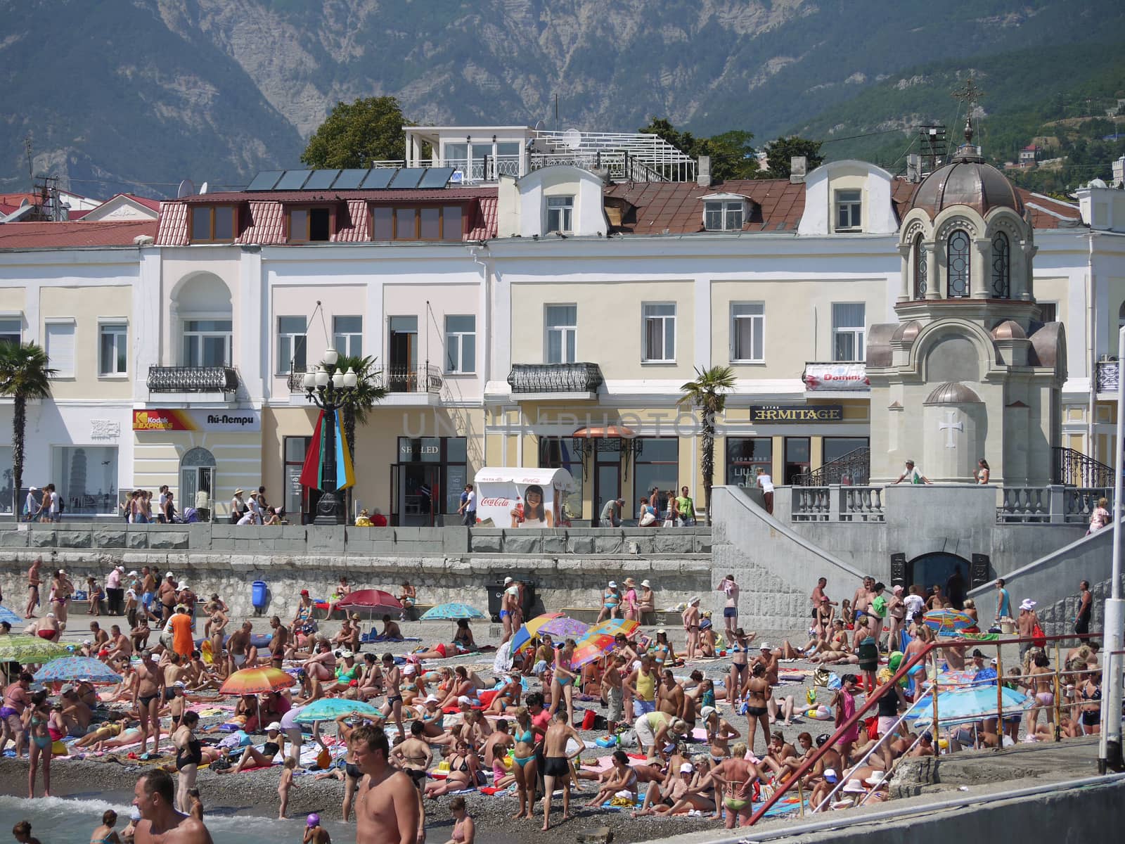 A beach where a lot of tourists and vacationers rest. For convenience near the beach there is a lot of different shops