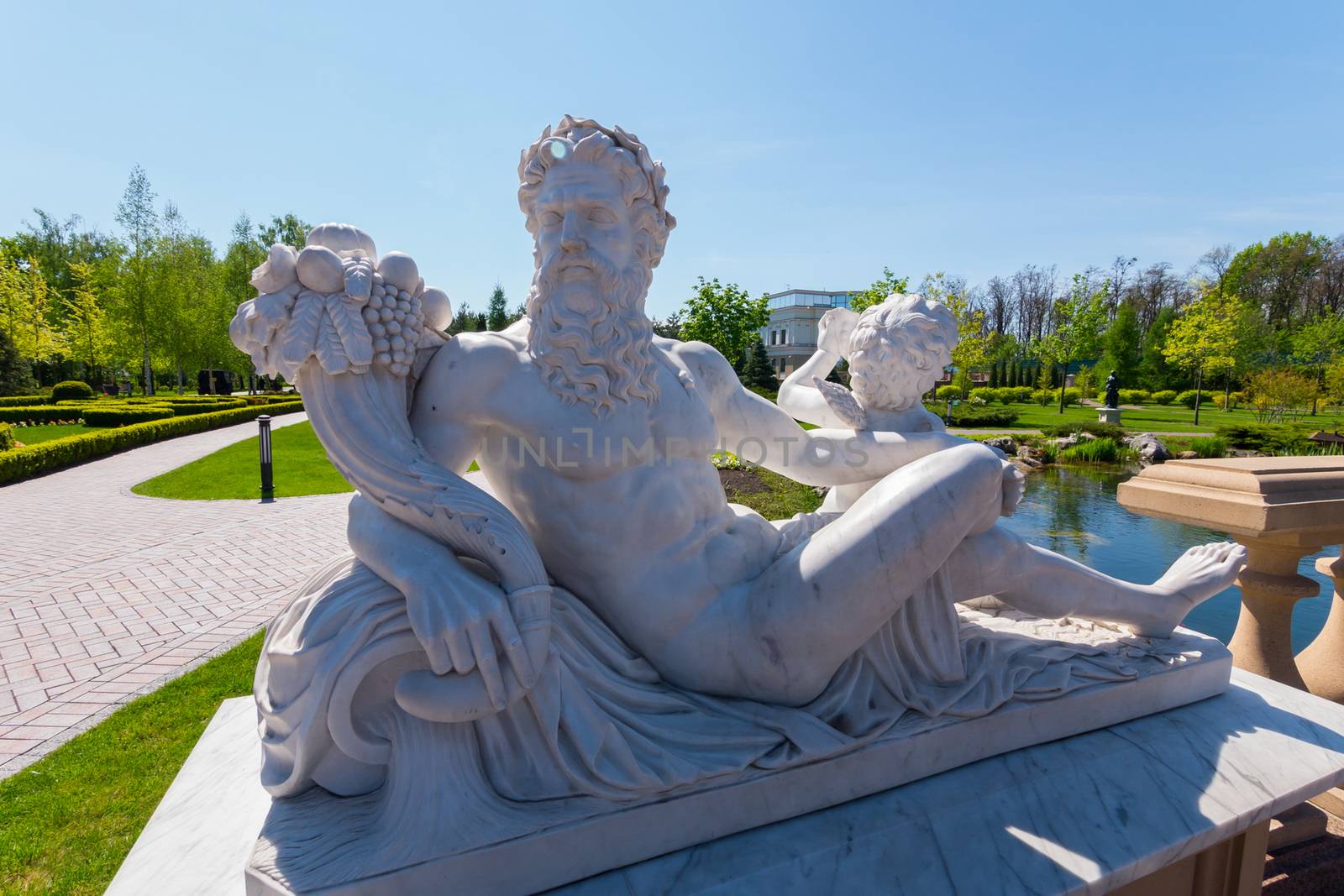 Statue of Dionysus with a bouquet of grapes on the background of by Adamchuk