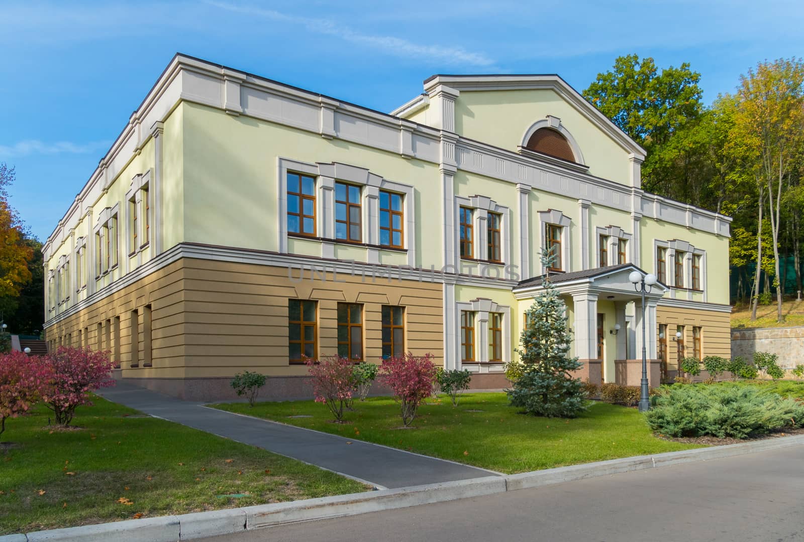 Two-colored, two-story building. One floor is coffee, the second is green. And the windows are high