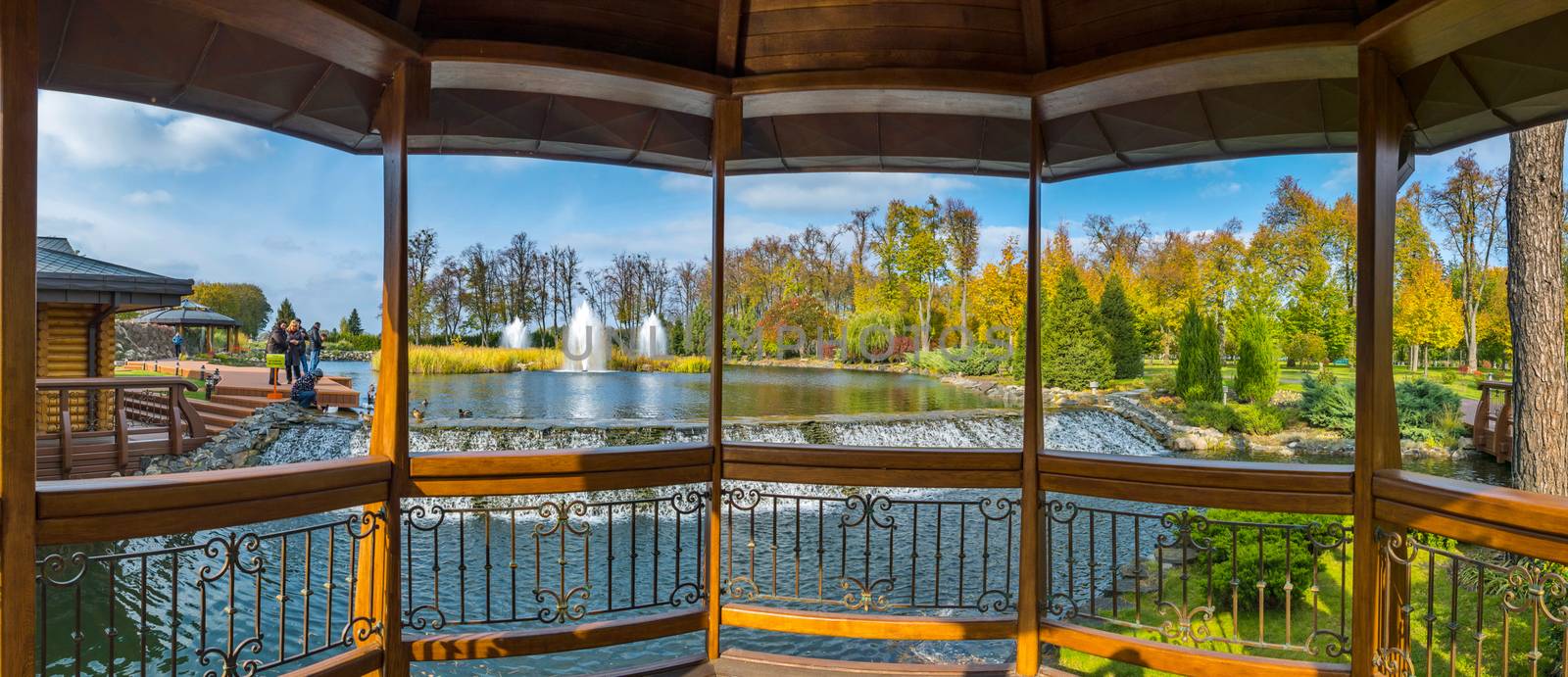 Luxurious view from the gazebo to relax on a pond with fountains by Adamchuk