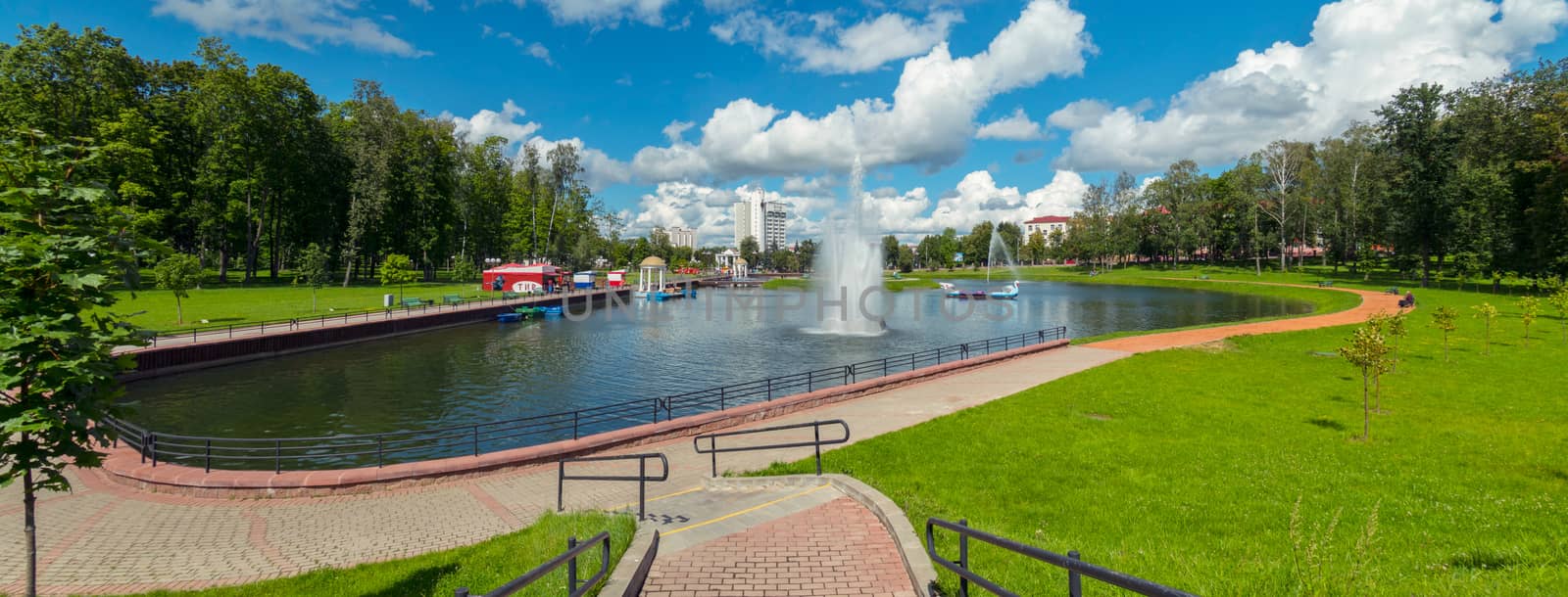 city park with a fountain and a lake on a clear day