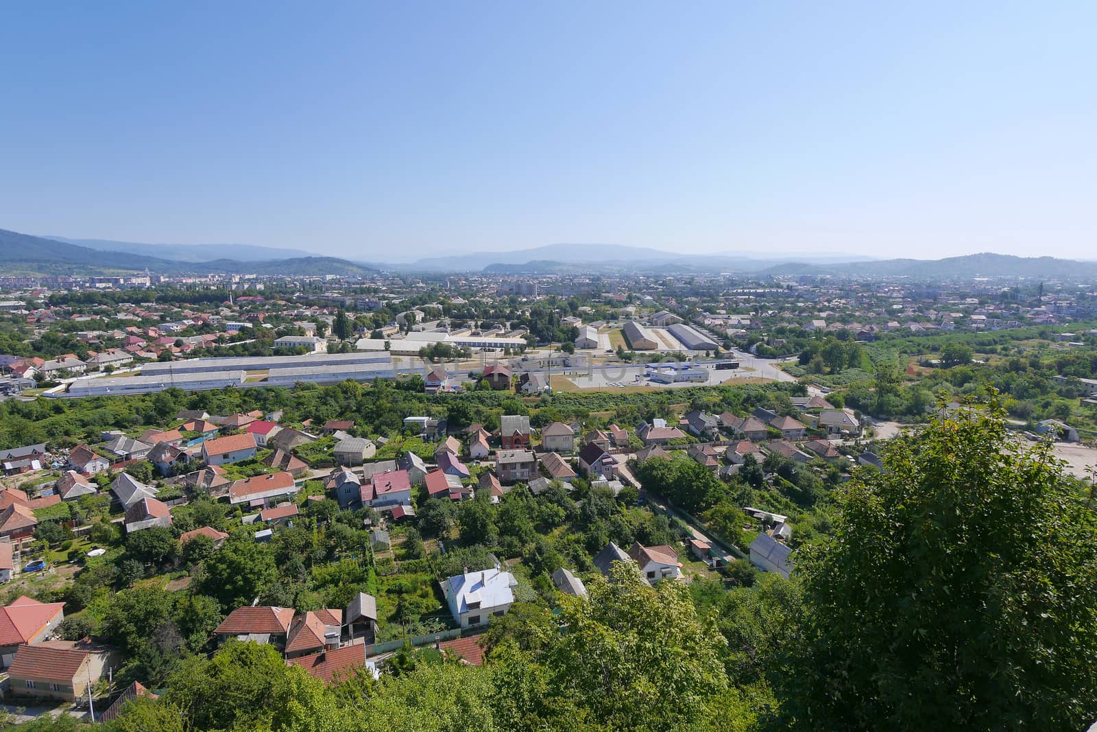 a panorama of red roofs of the city of Mukachevo and far hills from the observation tower of the palanque castle