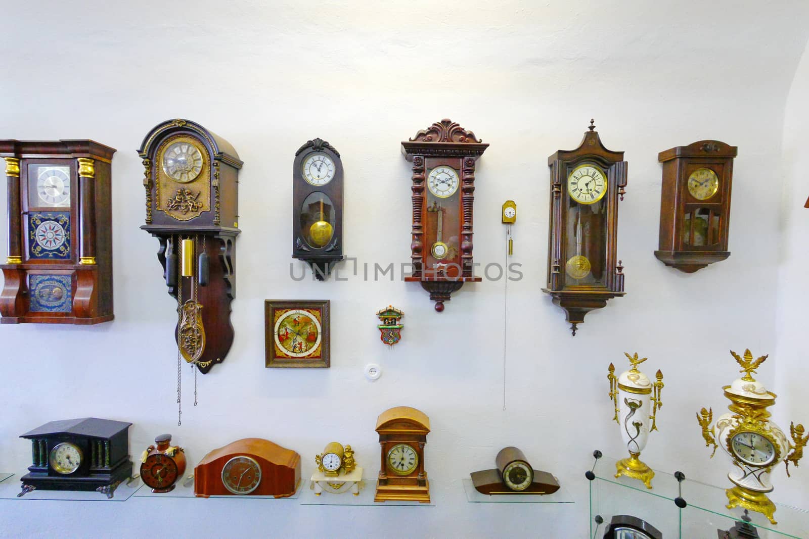 A huge number of antique wall clockwork with different dials and cases