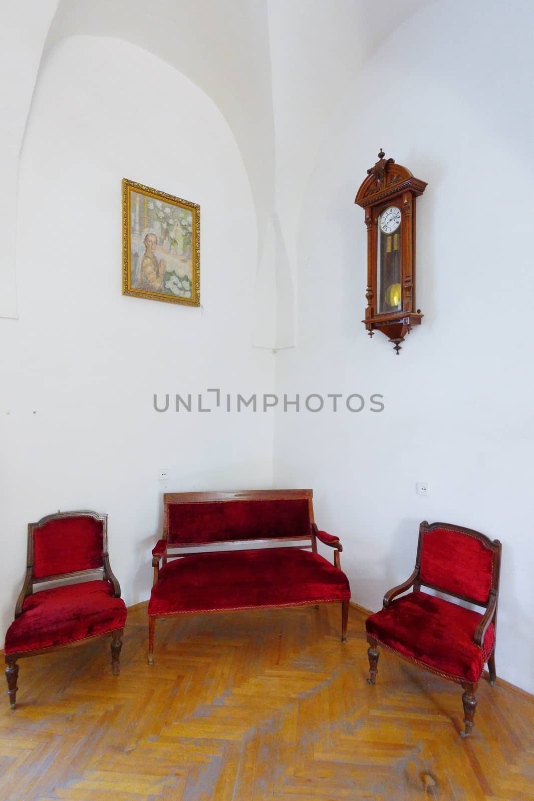 red sofa and two armchairs pattern and antique clock by Adamchuk