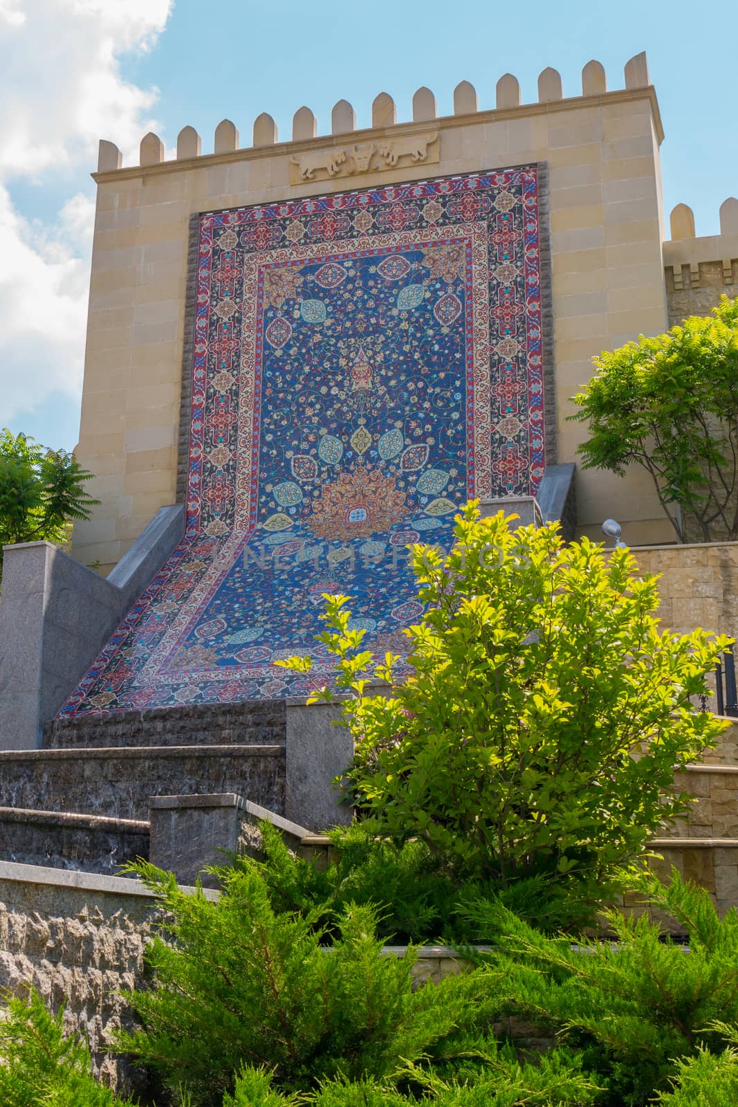 lined with a bright colored mosaic pattern in the form of a carpet on a concrete wall