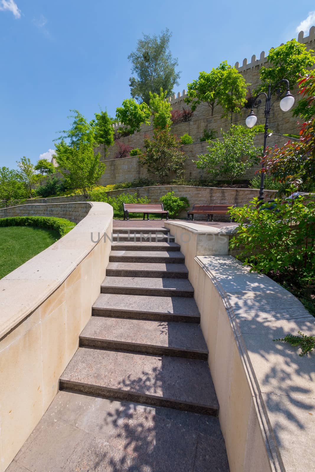 stepped wall with prongs on top with trees planted