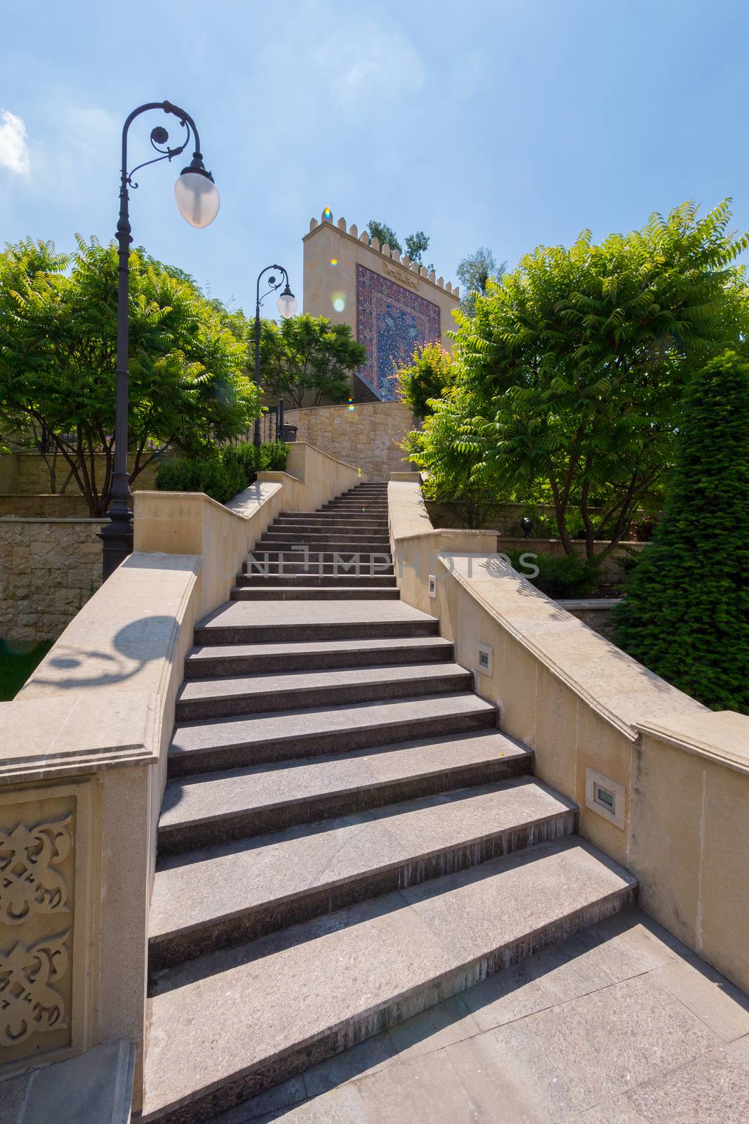 Steps with a lantern and planted next to trees by Adamchuk