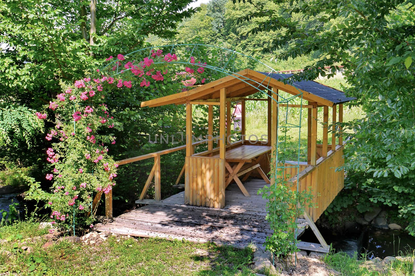 A beautiful wooden gazebo in the garden, for cozy summer farmhouses in the evening for a bottle of beer or a glass of wine