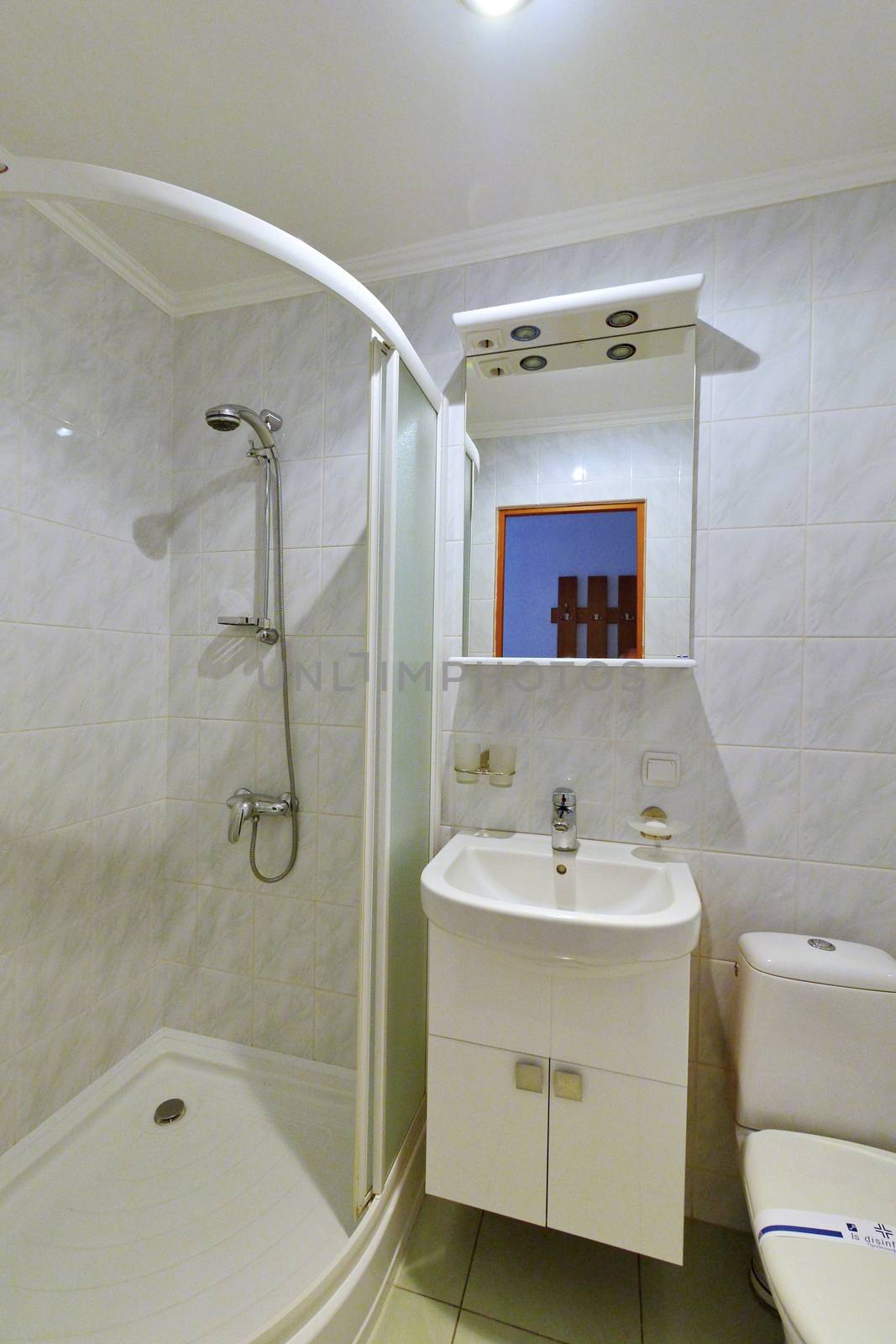 Combined bathroom with European-quality renovation laid out with white tiles stretched ceiling shower and modern equipment.