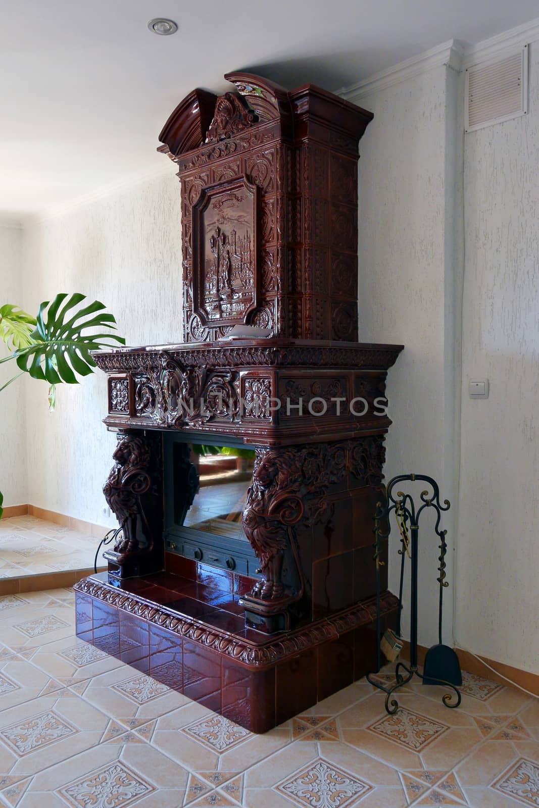 Beautiful stone decorative fireplace with a scoop and brush for cleaning coals