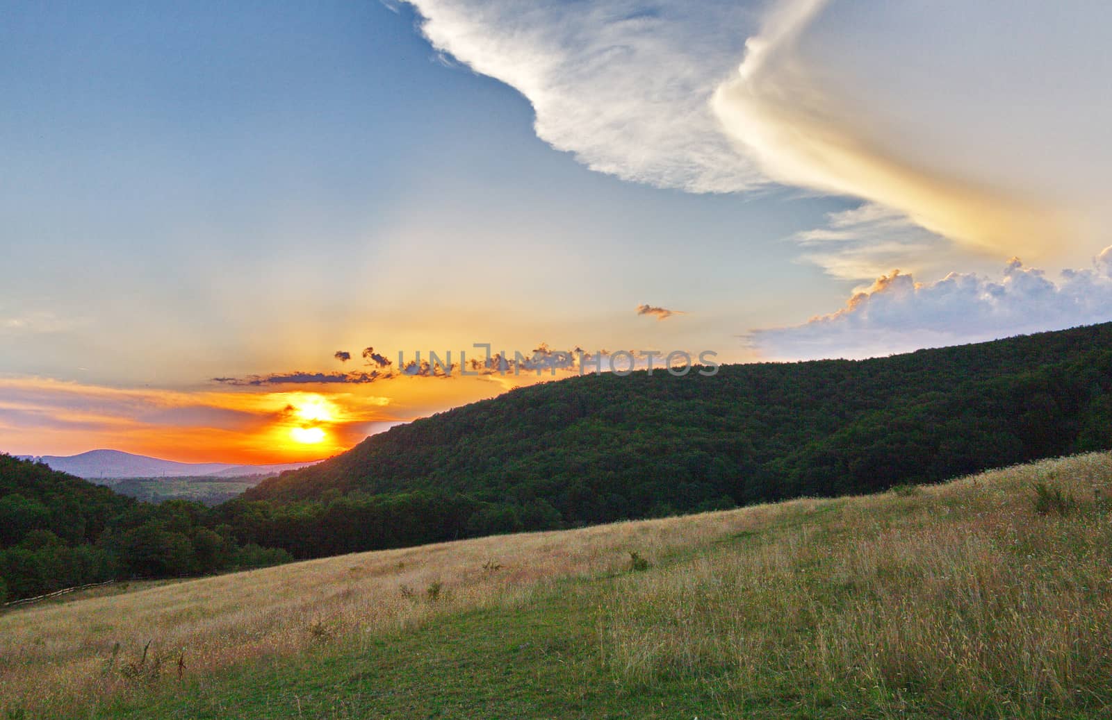 the beauty of a heavenly sunset against the backdrop of magnificent mountains