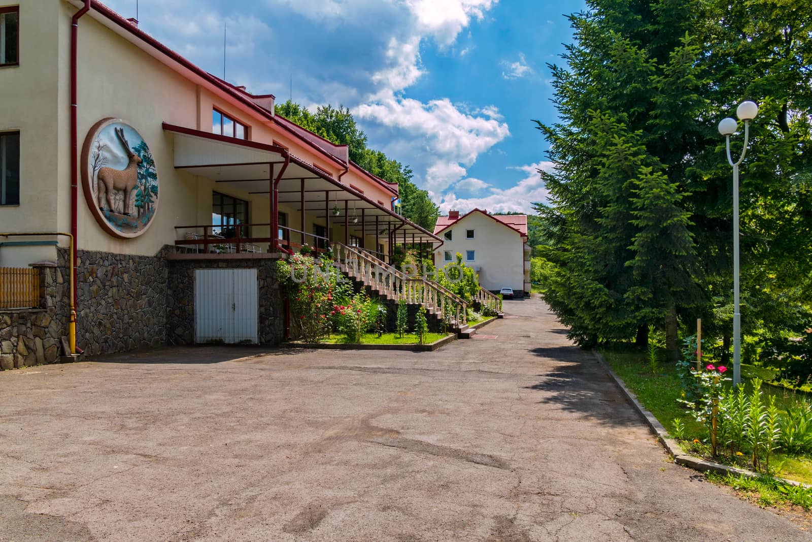 Deer's image on the hotel's fad with terraces and descent to the park