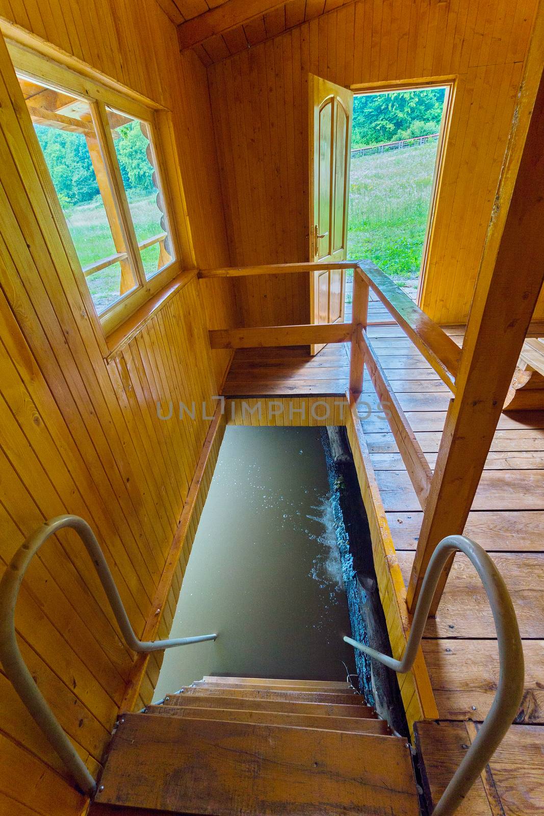 Entrance to a wooden bath with a staircase leading to a small pool with cold water