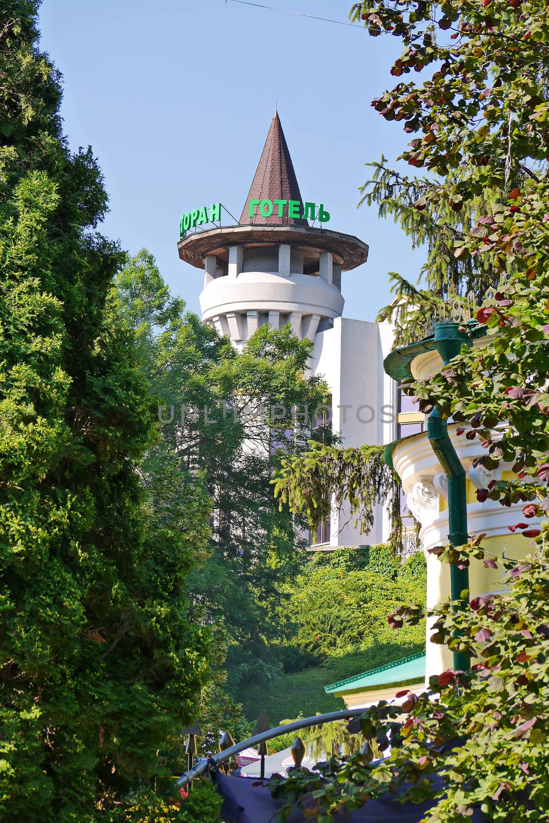 The cone-shaped top of the hotel building is similar to the gnome's cap by Adamchuk