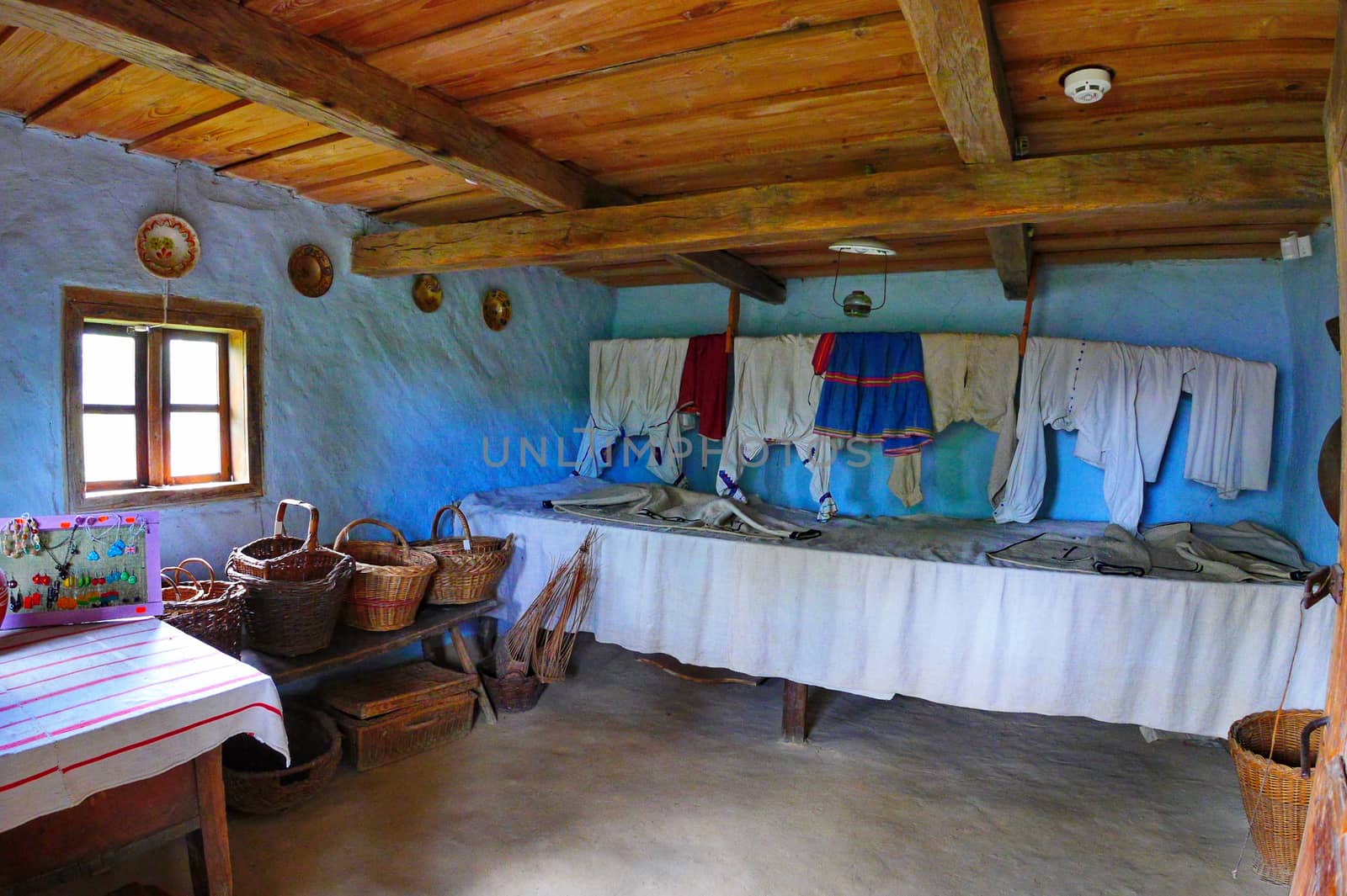 room in an old house with wicker baskets and household utensils