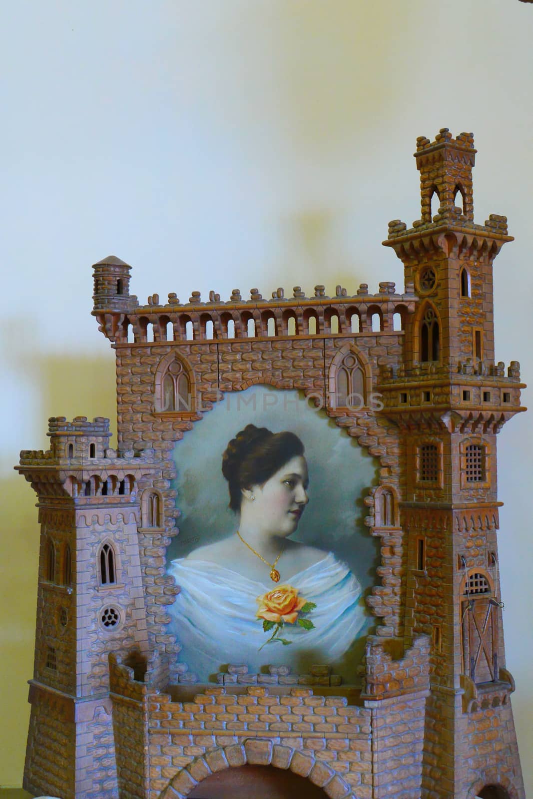 composition in the museum in the form of a wall with towers with a portrait of a woman in the middle