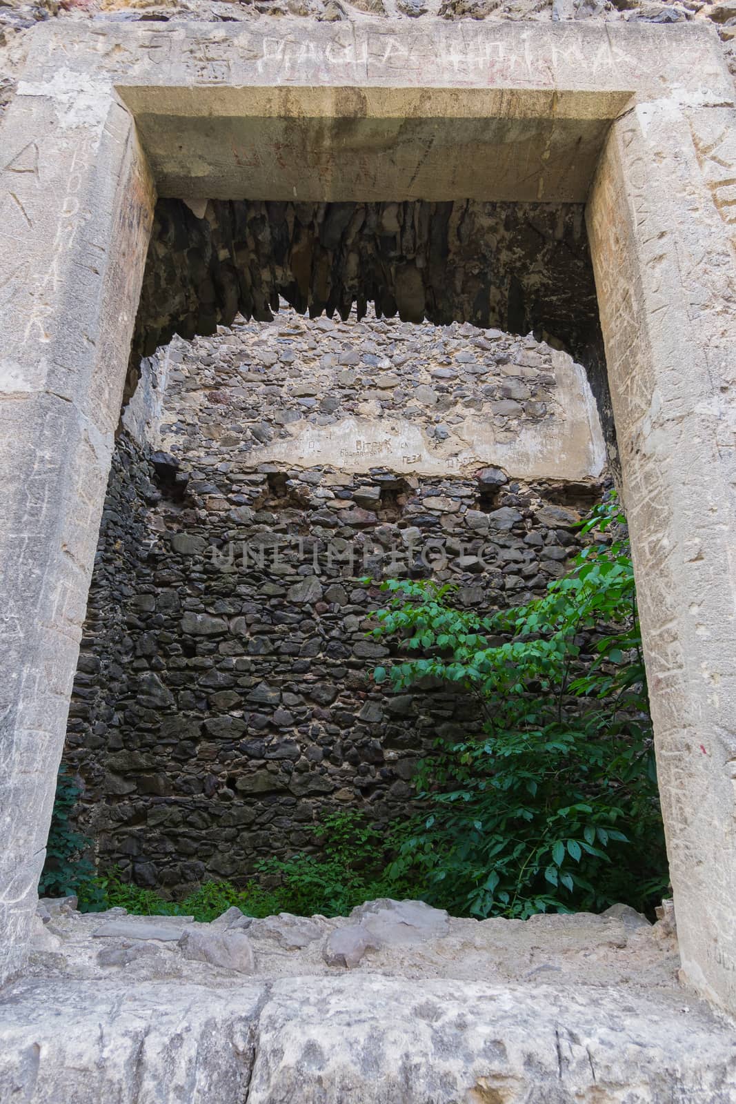 Stone old fortress wall with an opening in it. Historical value