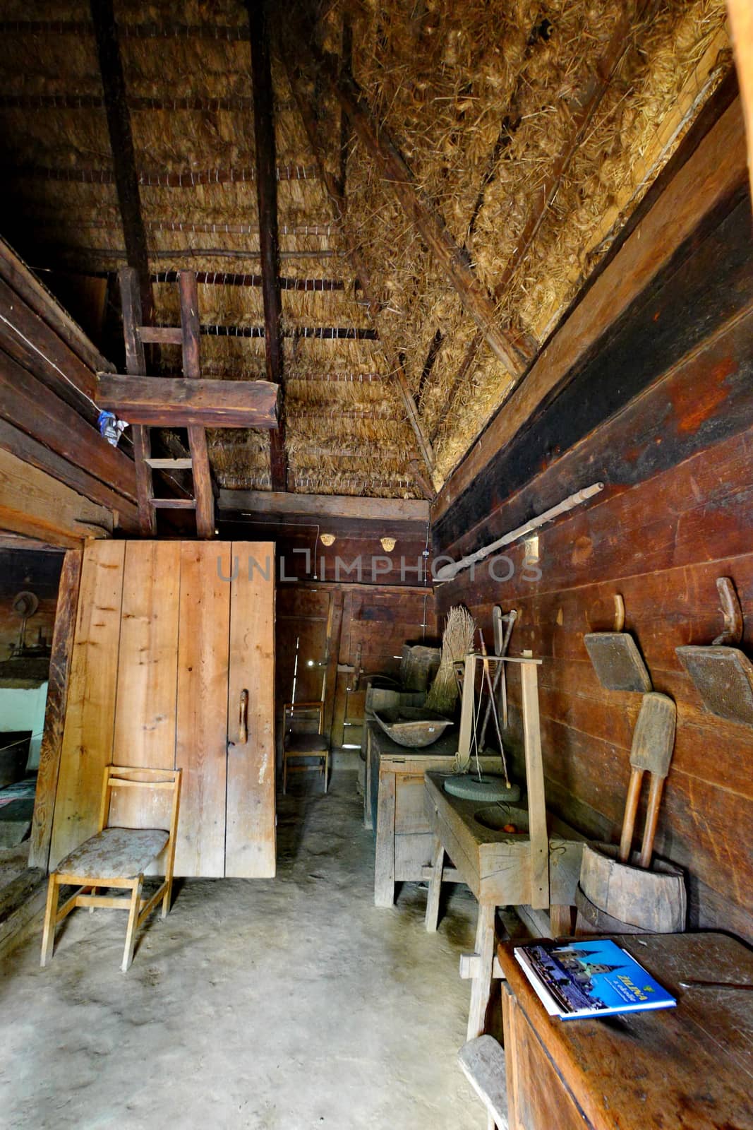 A small wooden hangar with a straw roof in which the working tools are stored by Adamchuk