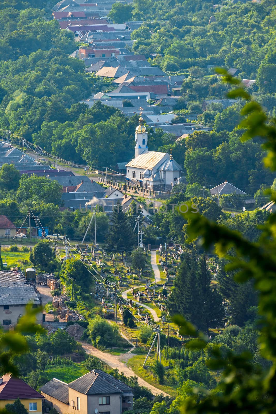 A delightful view of the church located in the middle of the village under the summer sky