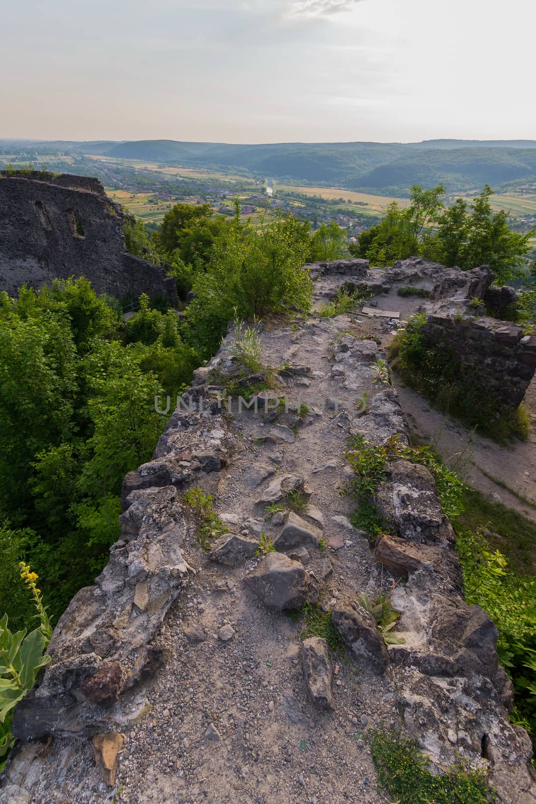 A stone wall enclosing an ancient fortress from enemies in the past by Adamchuk