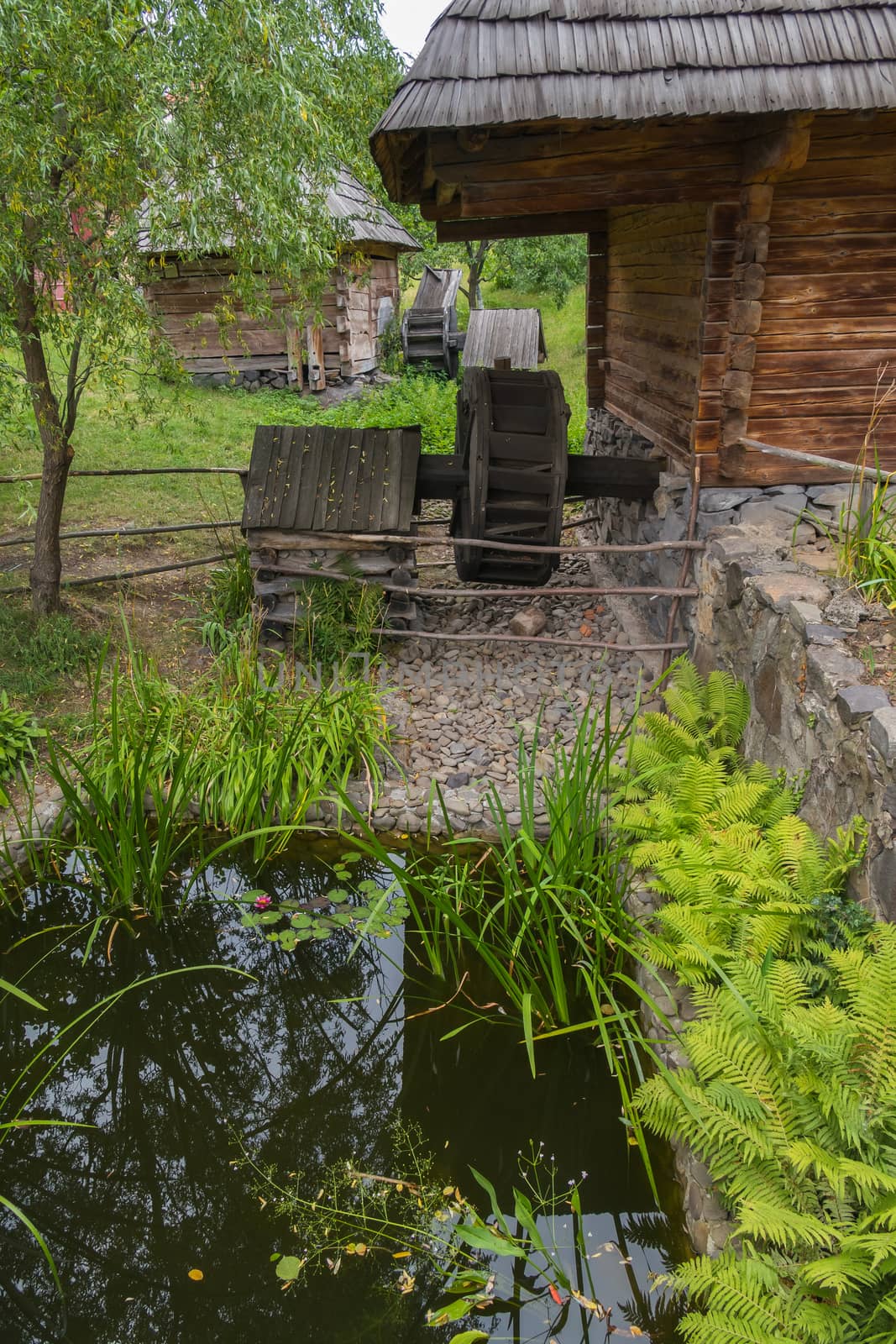 Old inn with a mill near a small pond. As in the Soviet cartoon Cossacks by Adamchuk