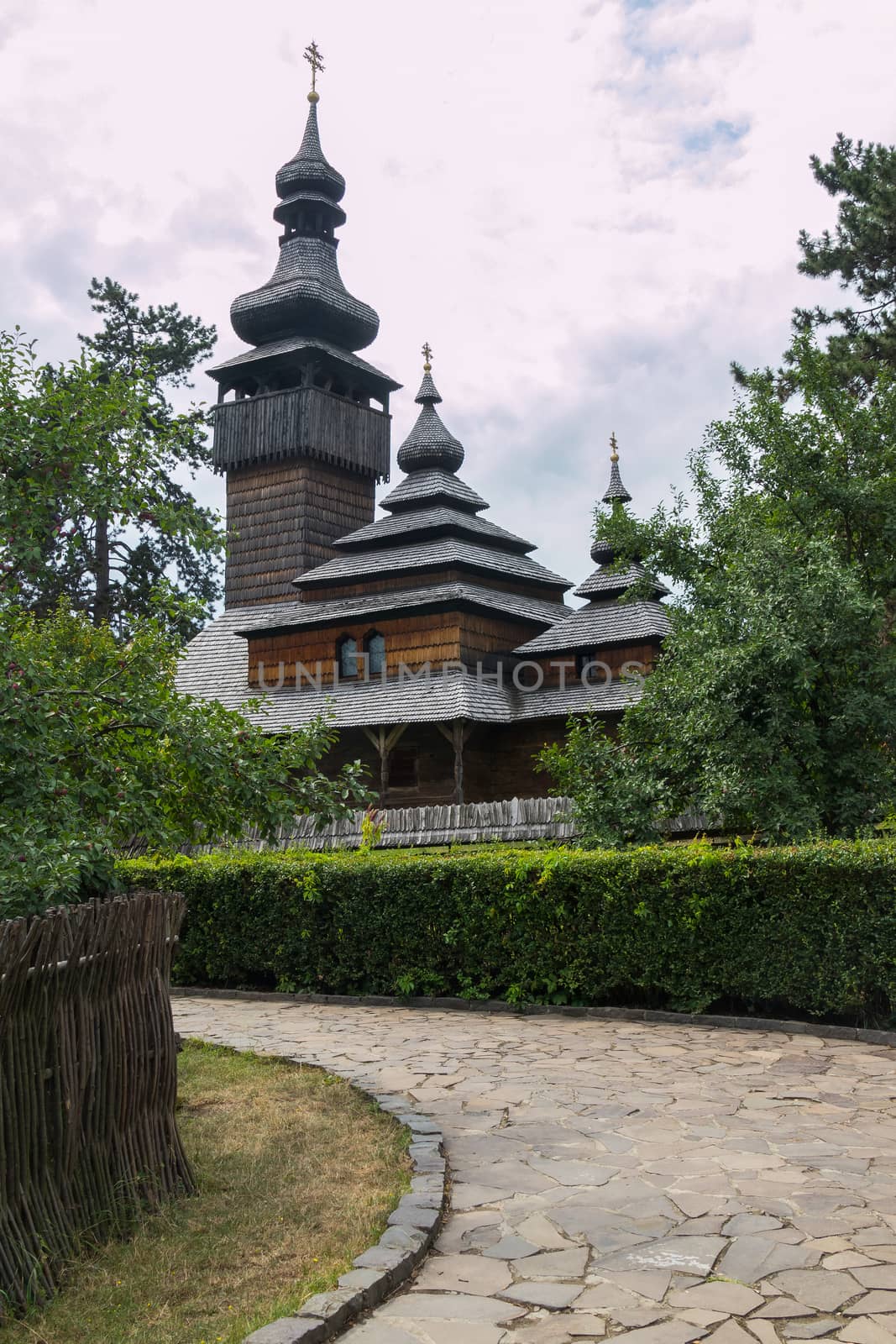 old cossack wooden church with bushes in the foreground