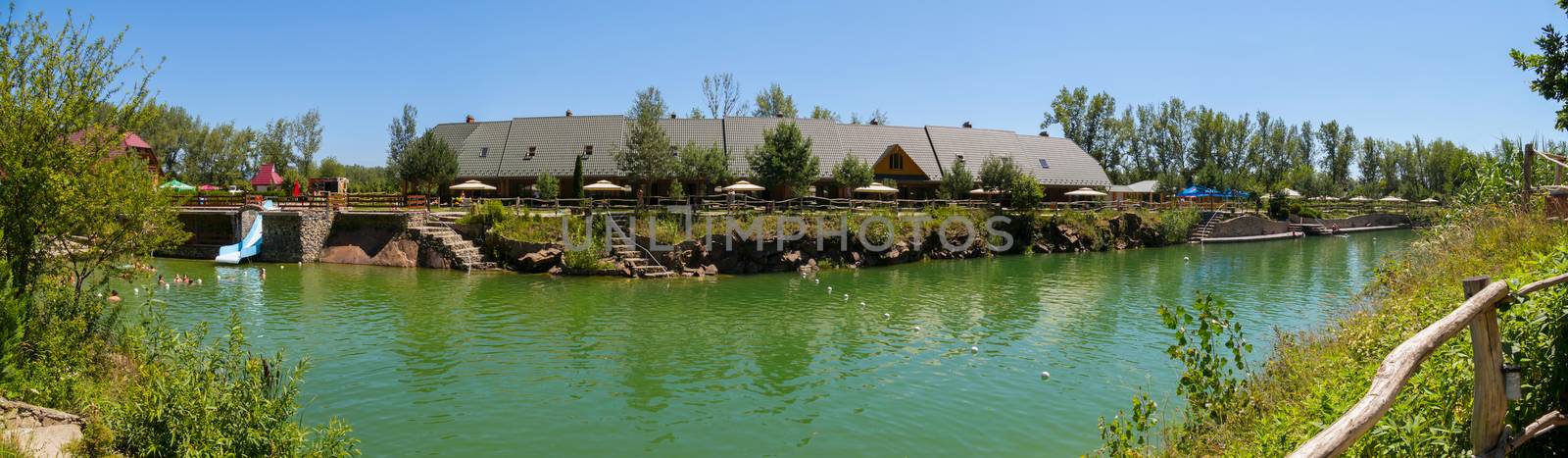 Scenic view of the beautiful transparent lake against the backdrop of the hotel complex