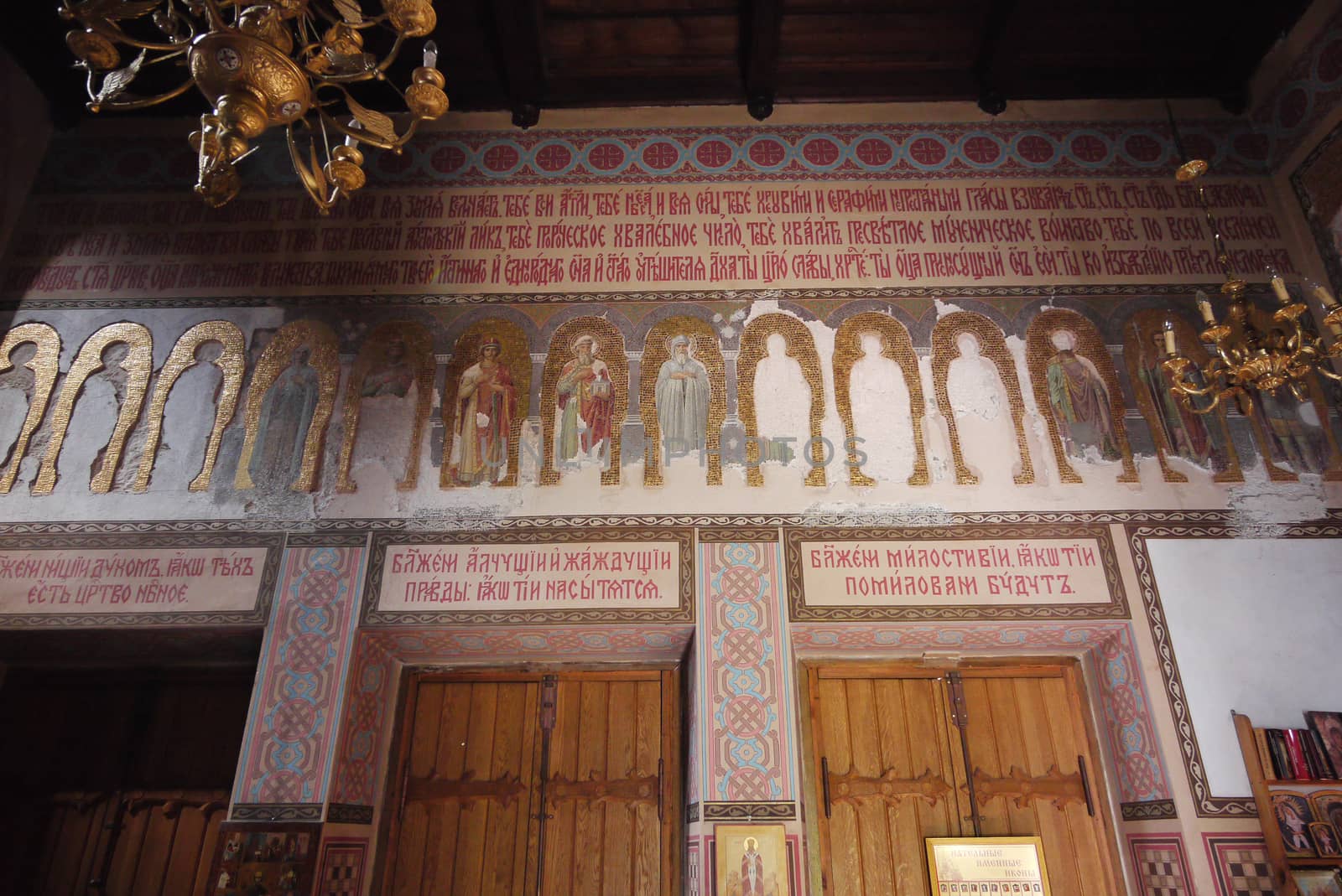 wall in the church with saints' faces and church texts