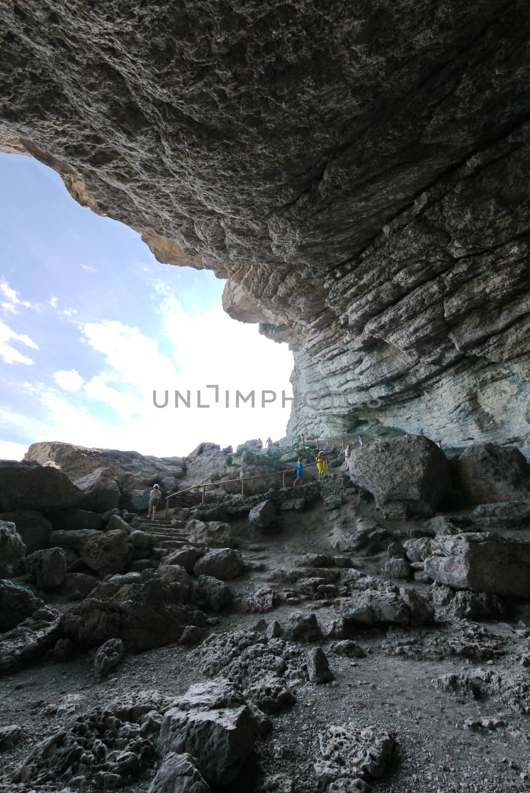 a gorge in the rocks with a pedestrian path with railing for tourists